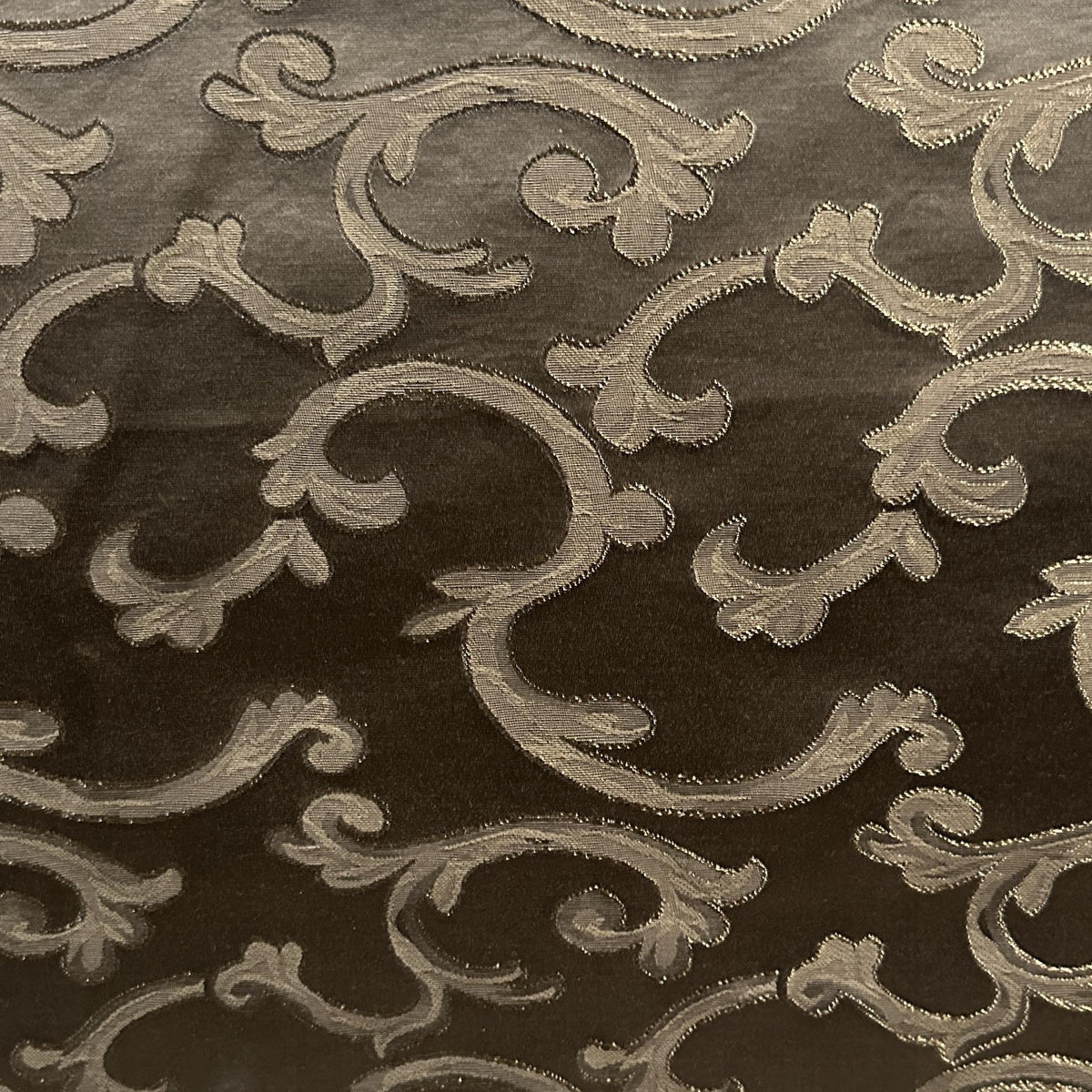 Brown and gold satin drapery fabric with a decorative pattern and smooth lustrous finish