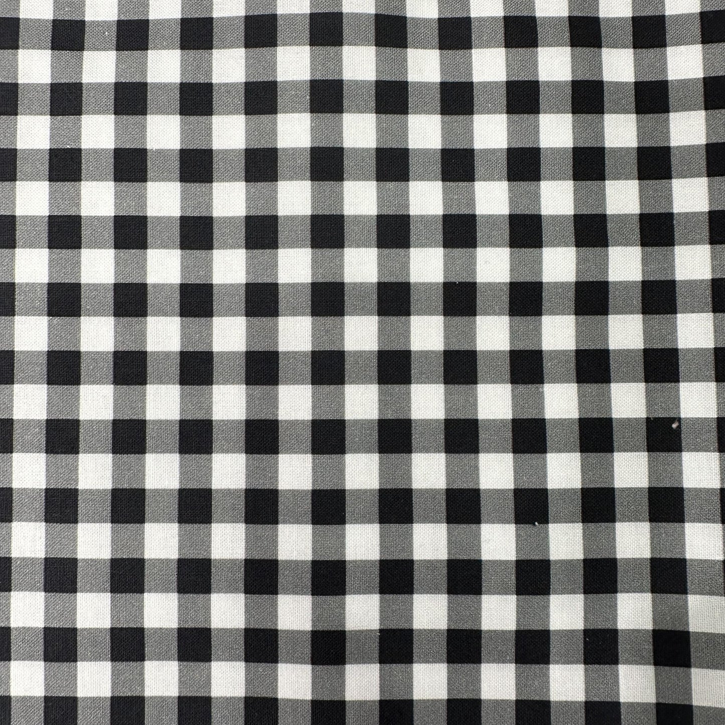 Black and white cotton fabric with a classic plaid checkered grid pattern