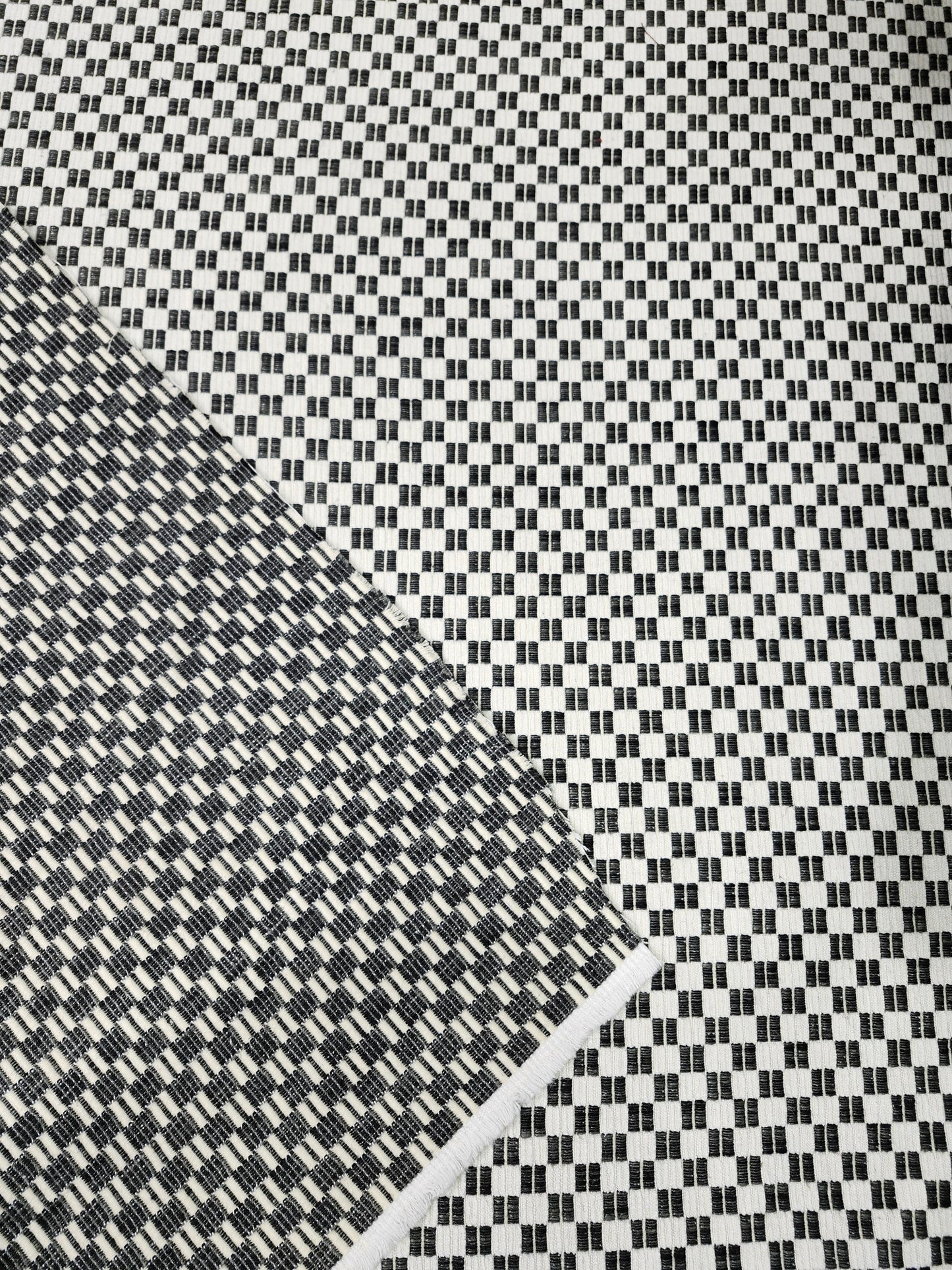 Black and white checkered poly cotton upholstery fabric with a classic woven pattern
