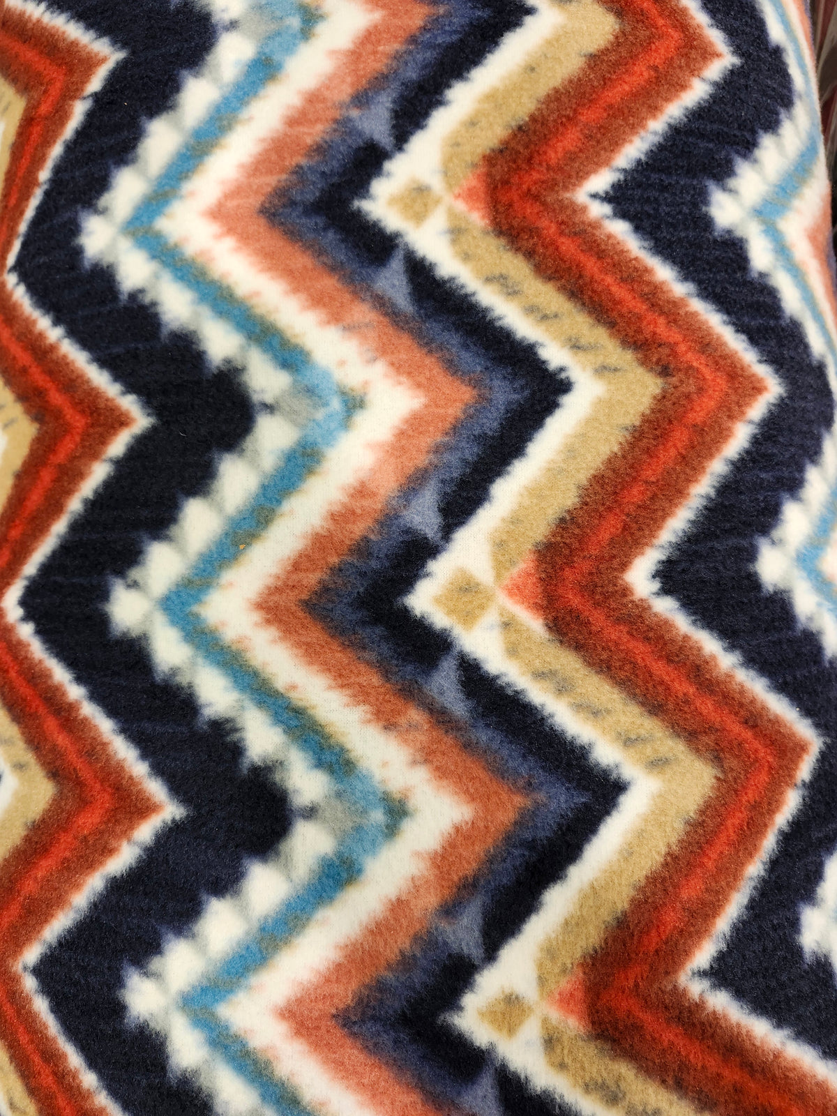 Soft polyester fleece fabric with a plush brushed texture for blankets, apparel, and crafts