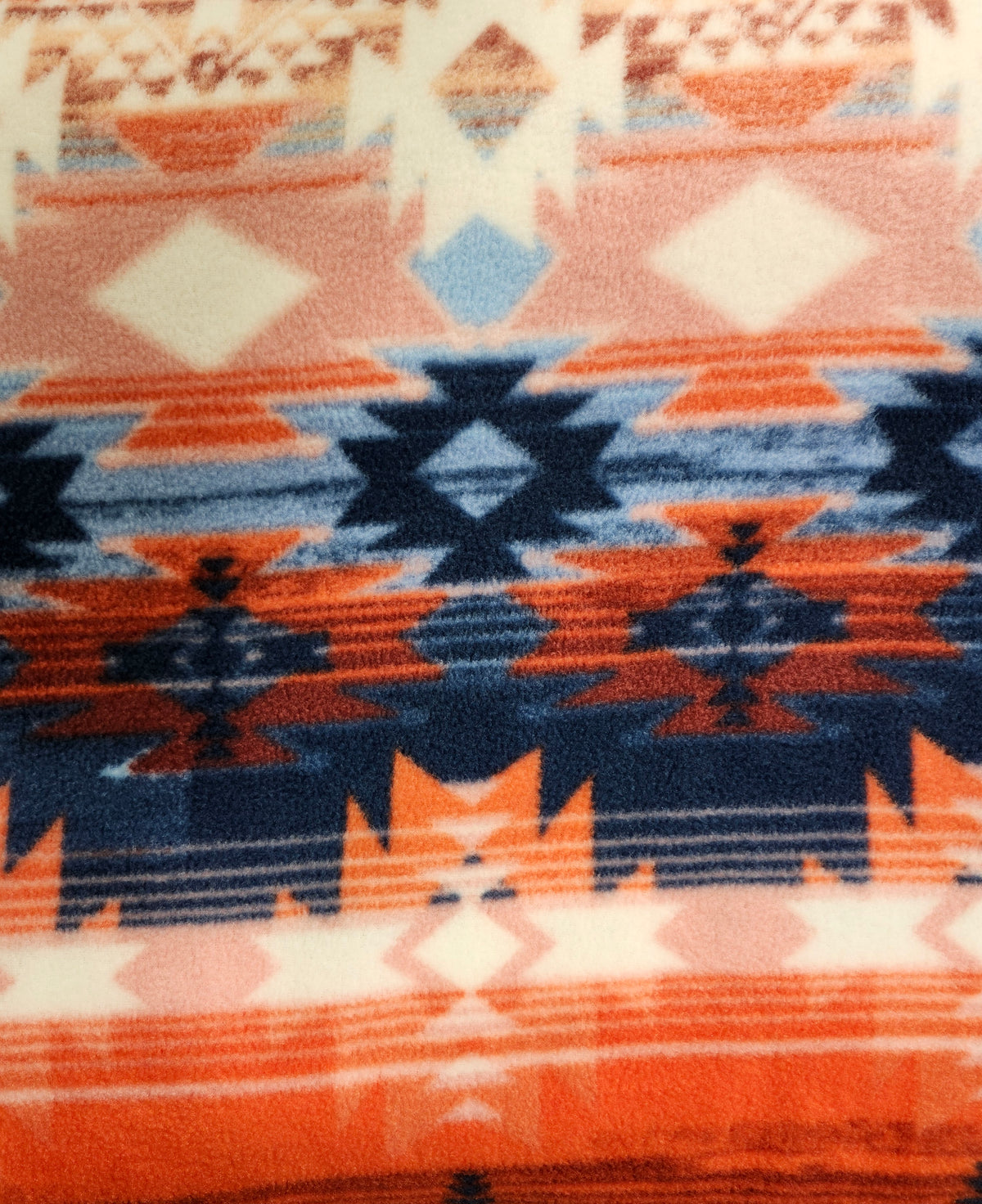 Soft Aztec polyester fleece fabric with a plush brushed texture for blankets, apparel, and crafts