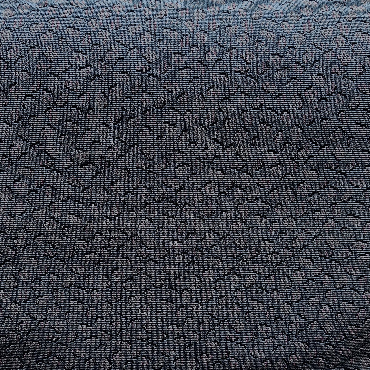 Teal blue upholstery fabric with a distinctive repeating pattern for furniture and home décor
