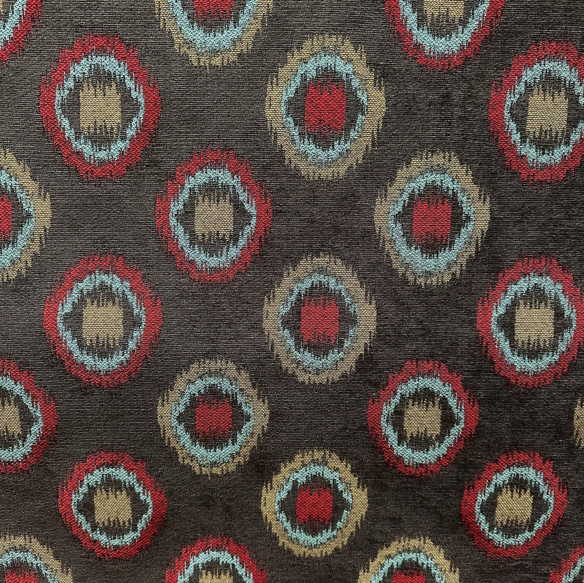 Brown polyester upholstery fabric with abstract fantasy eyes geometric pattern