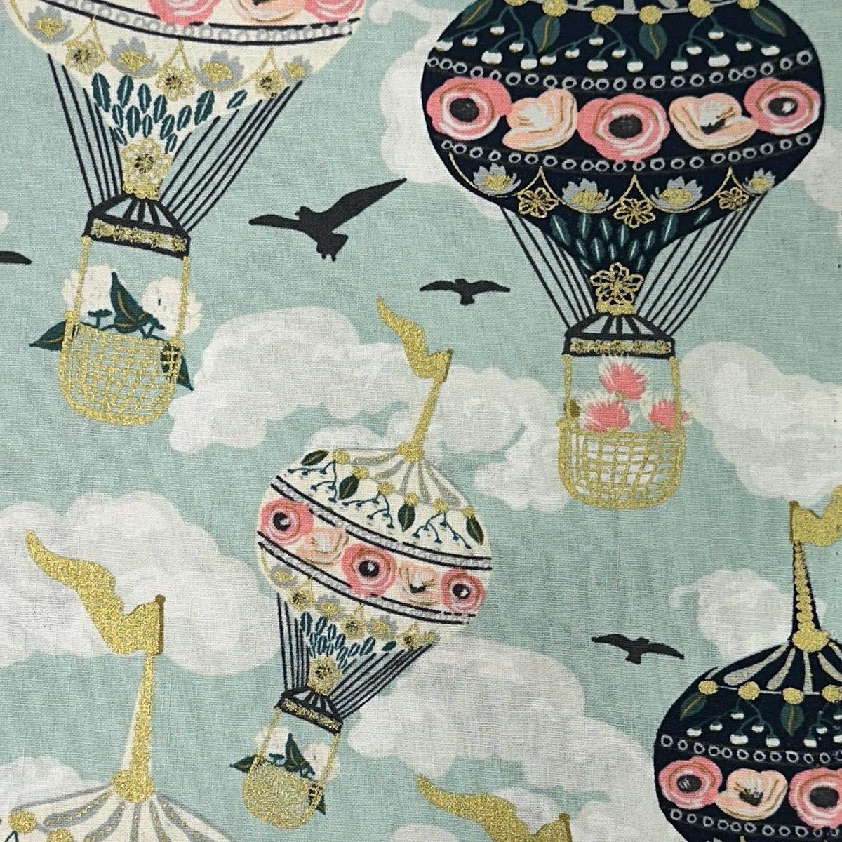 Multicolored cotton fabric with decorative design of hot air balloons, sky, clouds, and birds