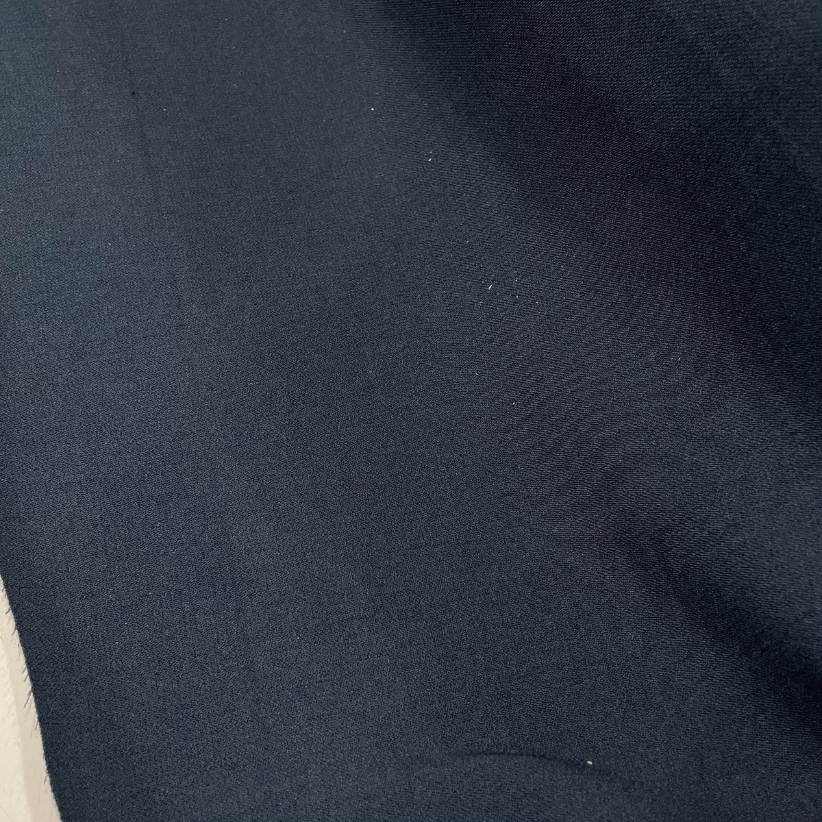 Navy blue stretch crepe polyester fabric with a subtly textured surface and solid colour