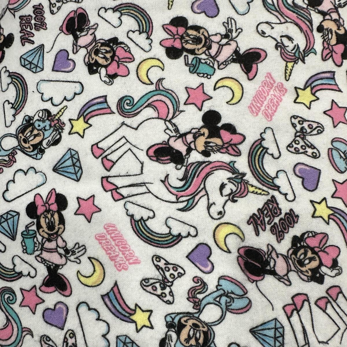 White Minnie Mouse and unicorns flannel fabric with rainbows, stars, hearts and colourful character motifs