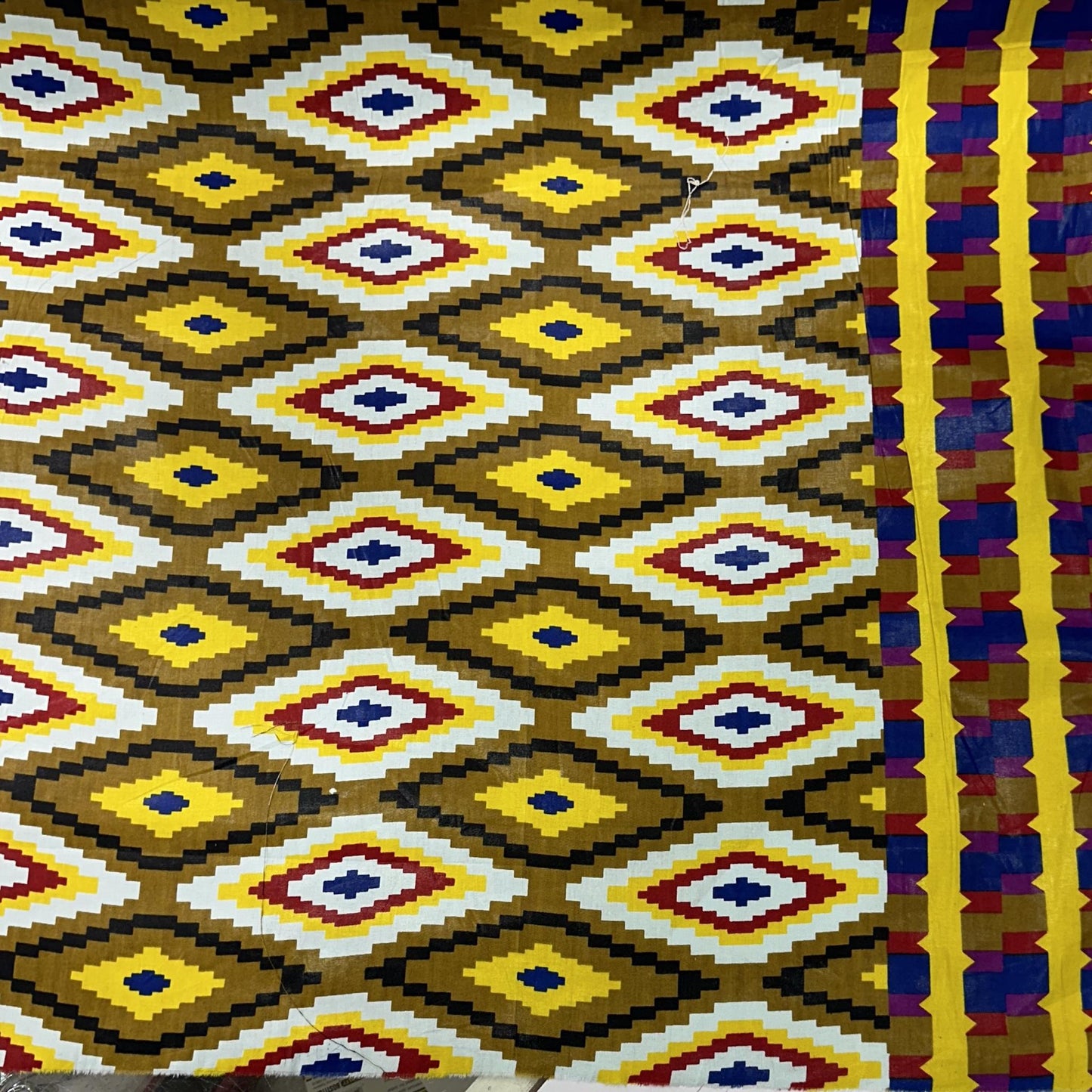 African wax cotton fabric with a colourful repeating geometric diamond pattern