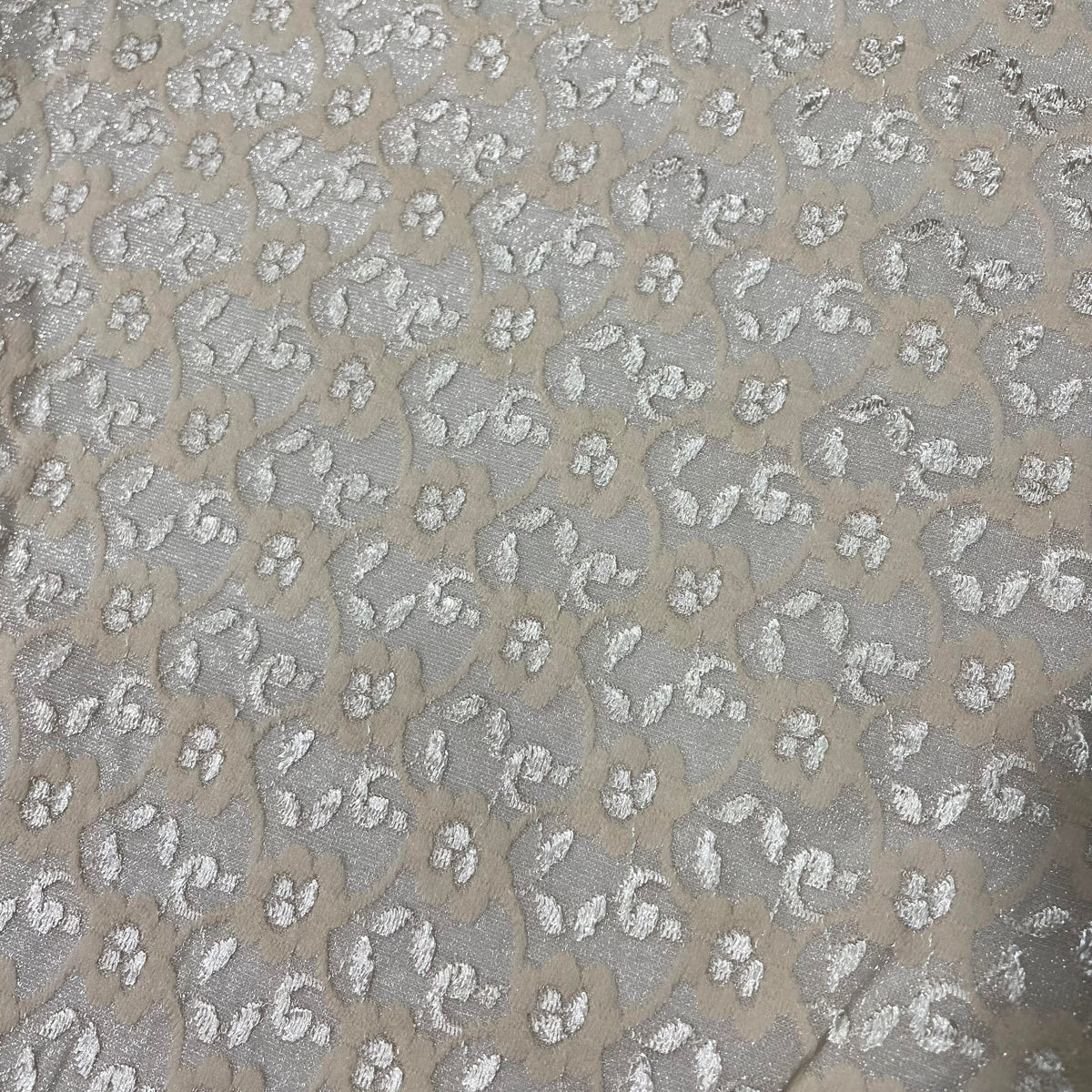 Champagne stretch lace fabric with a soft decorative openwork pattern and flexible construction