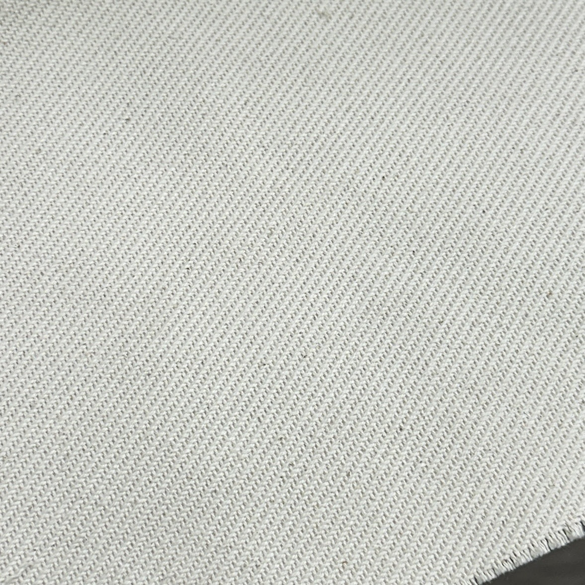 Natural 100% cotton twill fabric with a solid colour and textured diagonal weave