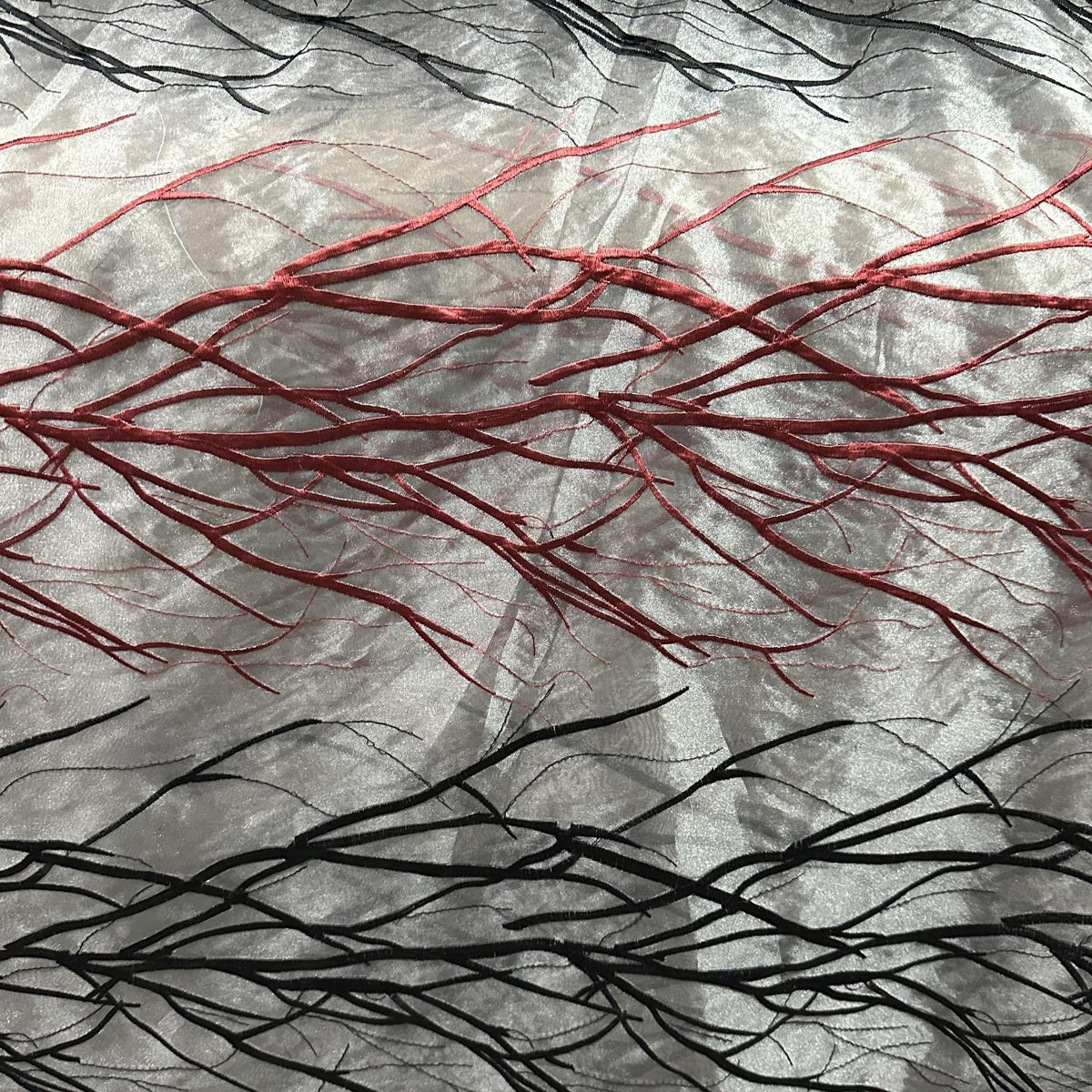 Silver grey, burgundy, and black wide-width drapery fabric with a decorative branch pattern