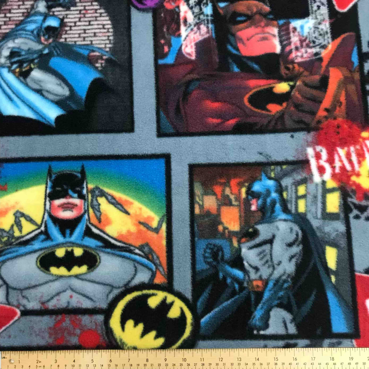Grey Batman fleece fabric featuring blue, red, and black superhero character print
