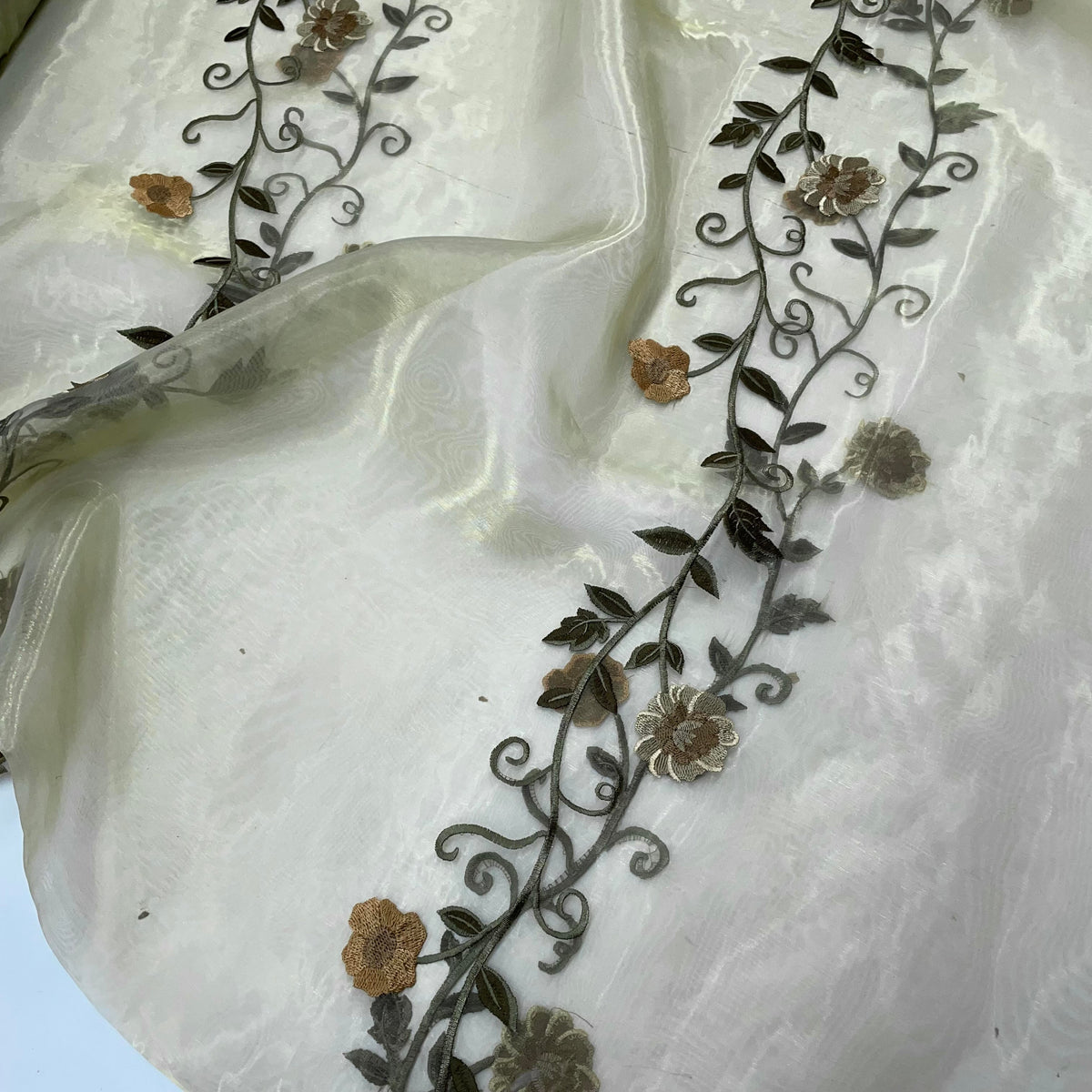 Iridescent polyester sheer fabric shifting between green and other tones