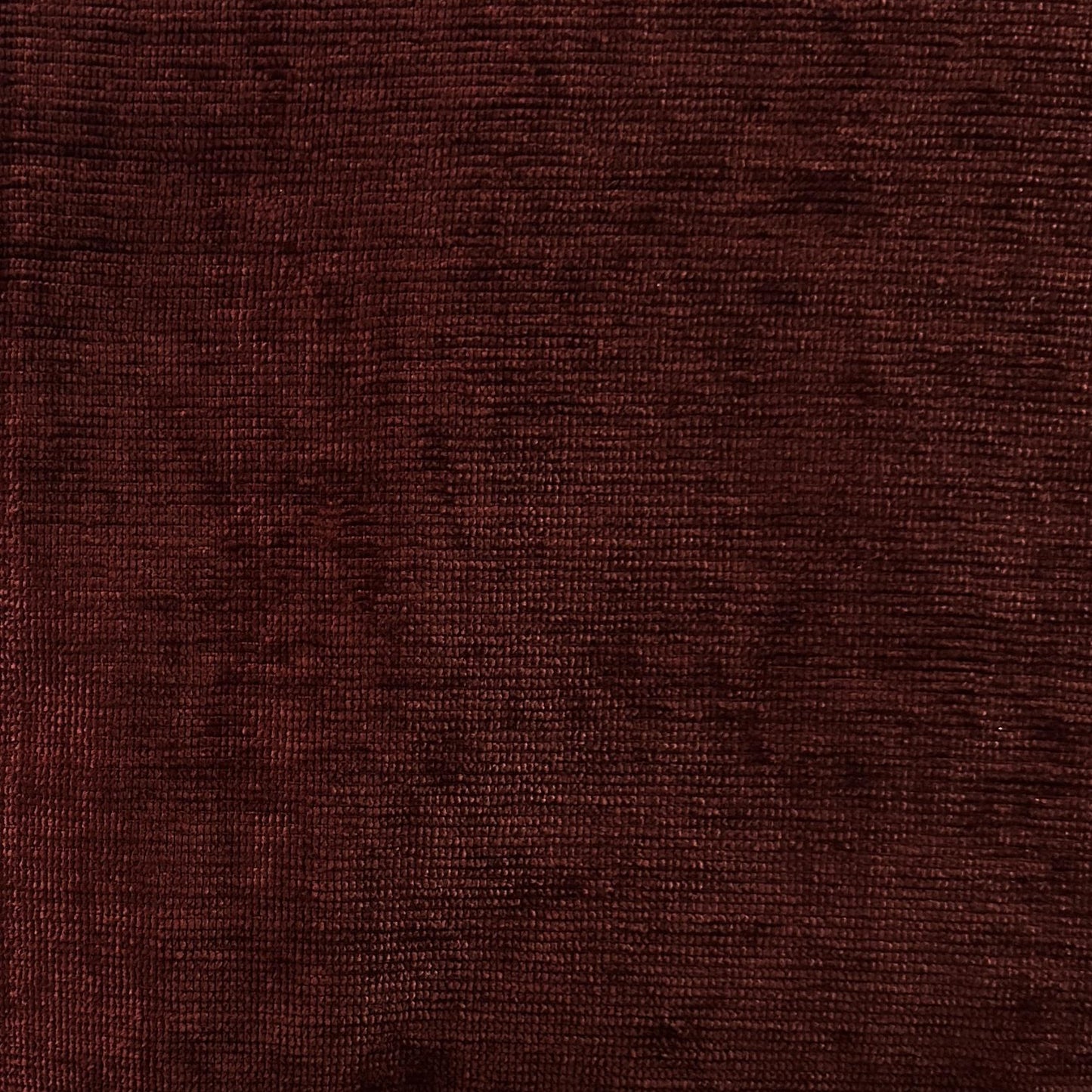 Cranberry red upholstery velvet fabric with a soft solid textured surface