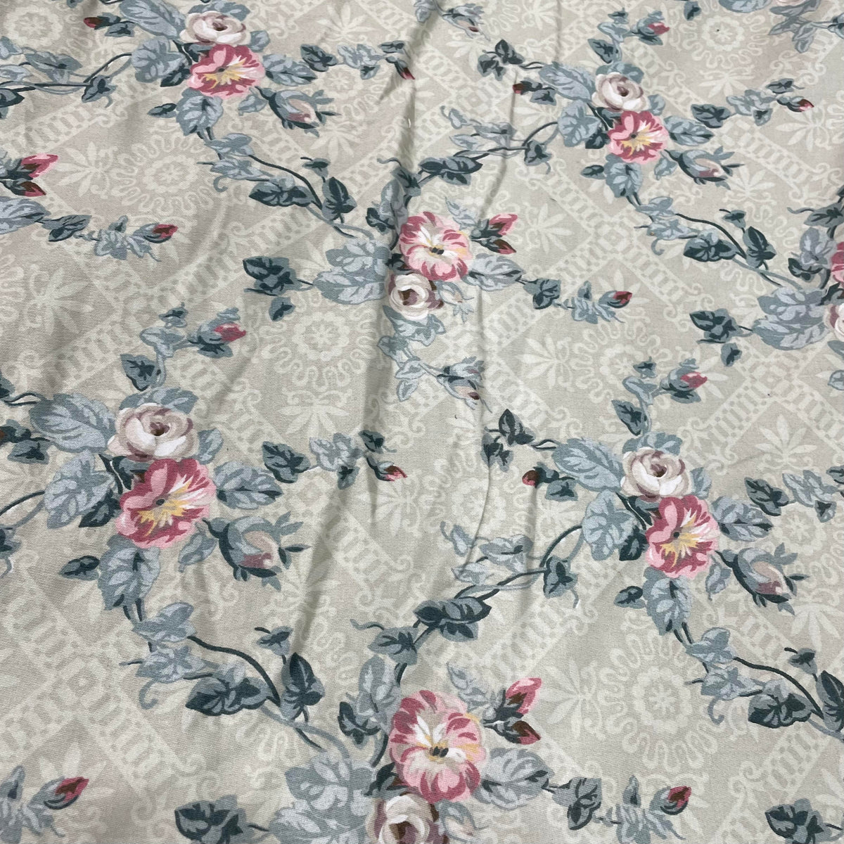 100% cotton fabric with a decorative floral vine botanical pattern