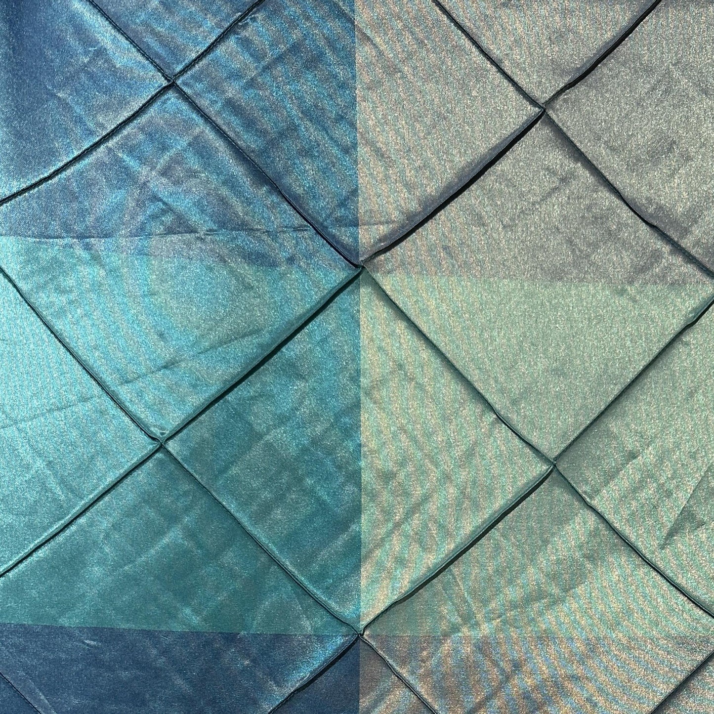 Blue and green wide-width taffeta polyester fabric with a geometric diamond checker pattern