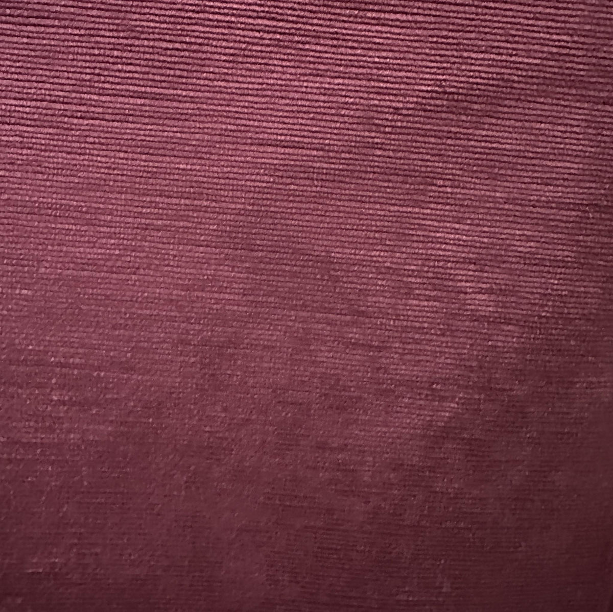 Solid purple velvet upholstery fabric with a soft surface and subtle tonal texture