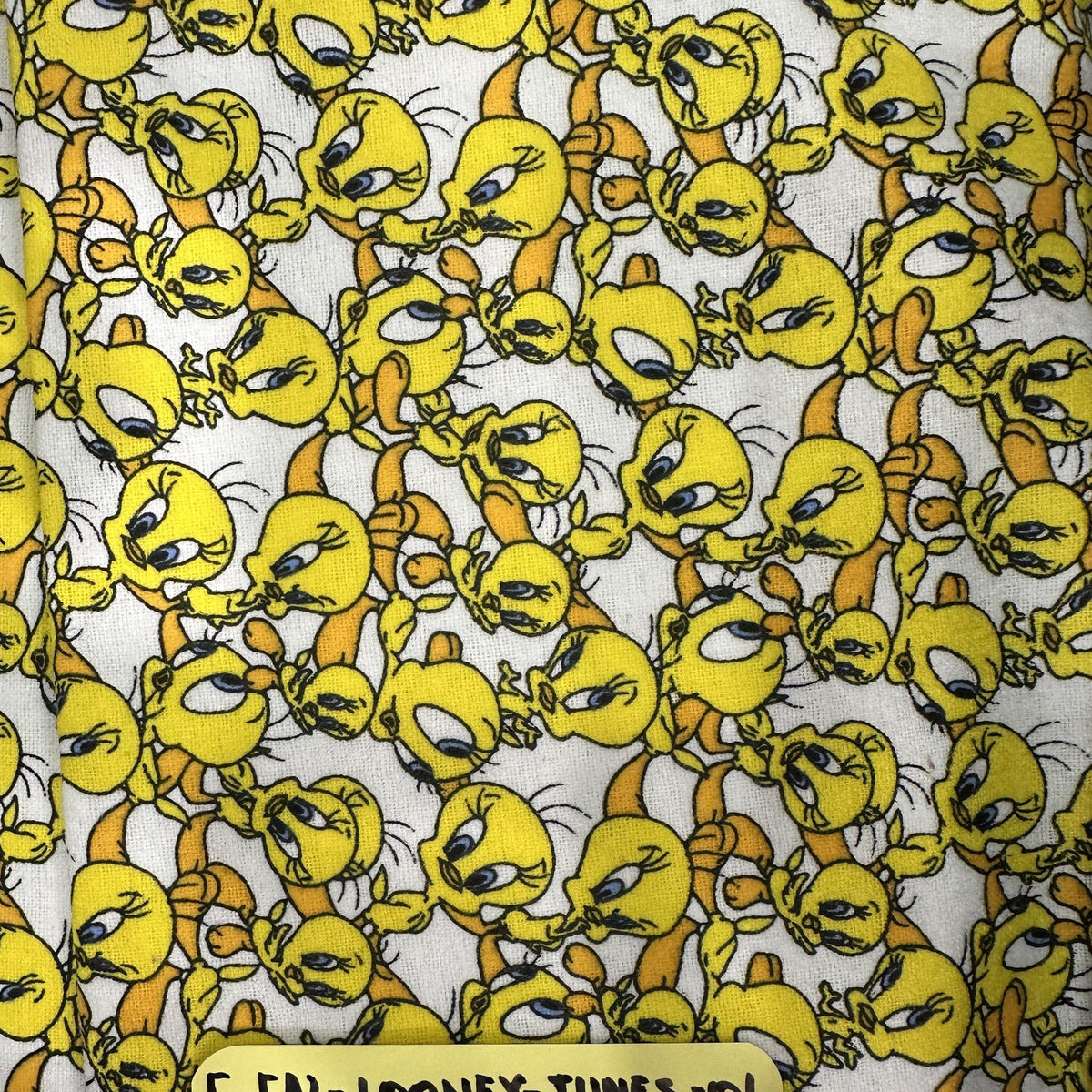 Yellow and white Tweety Bird Looney Tunes cotton flannel fabric with a playful character print