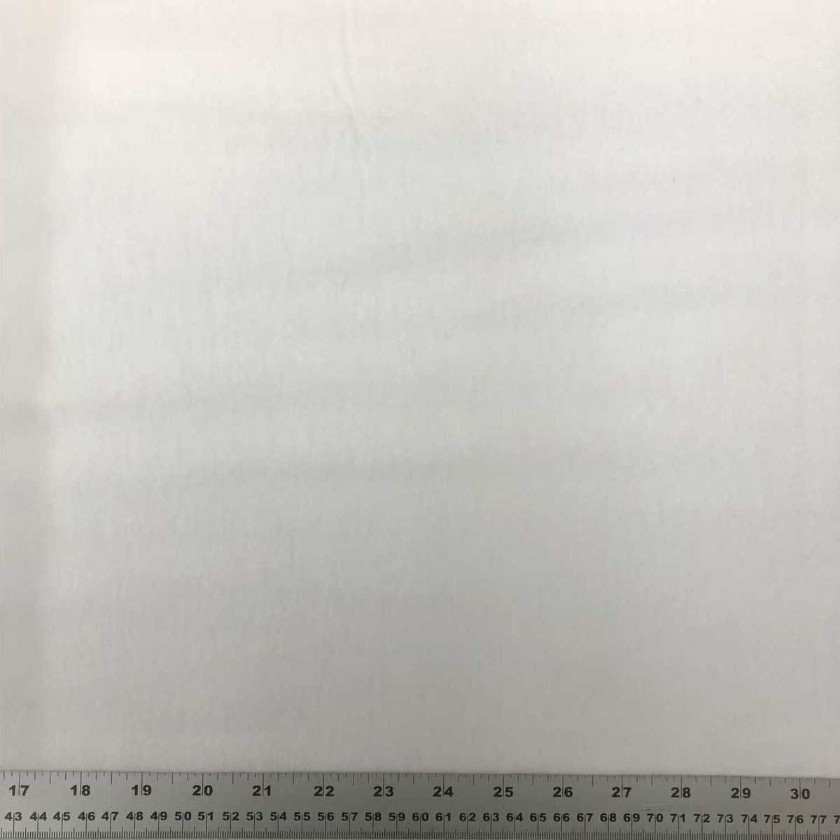 Solid white cotton flannel fabric with a soft, smooth flannelette surface