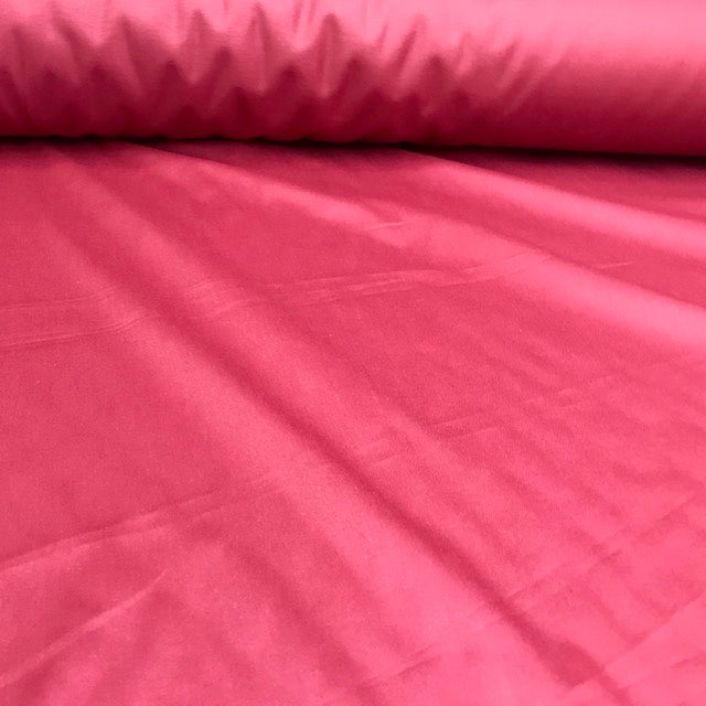Solid burgundy cotton fabric with a smooth woven surface