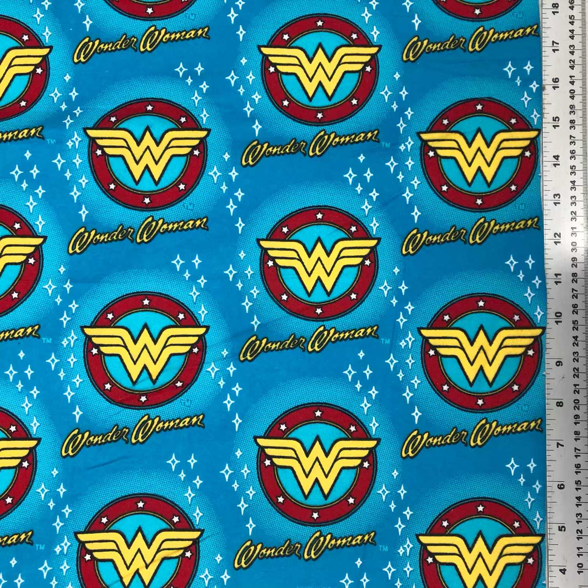 Blue Wonder Woman cotton flannel with red and yellow logos, script lettering and white star accents
