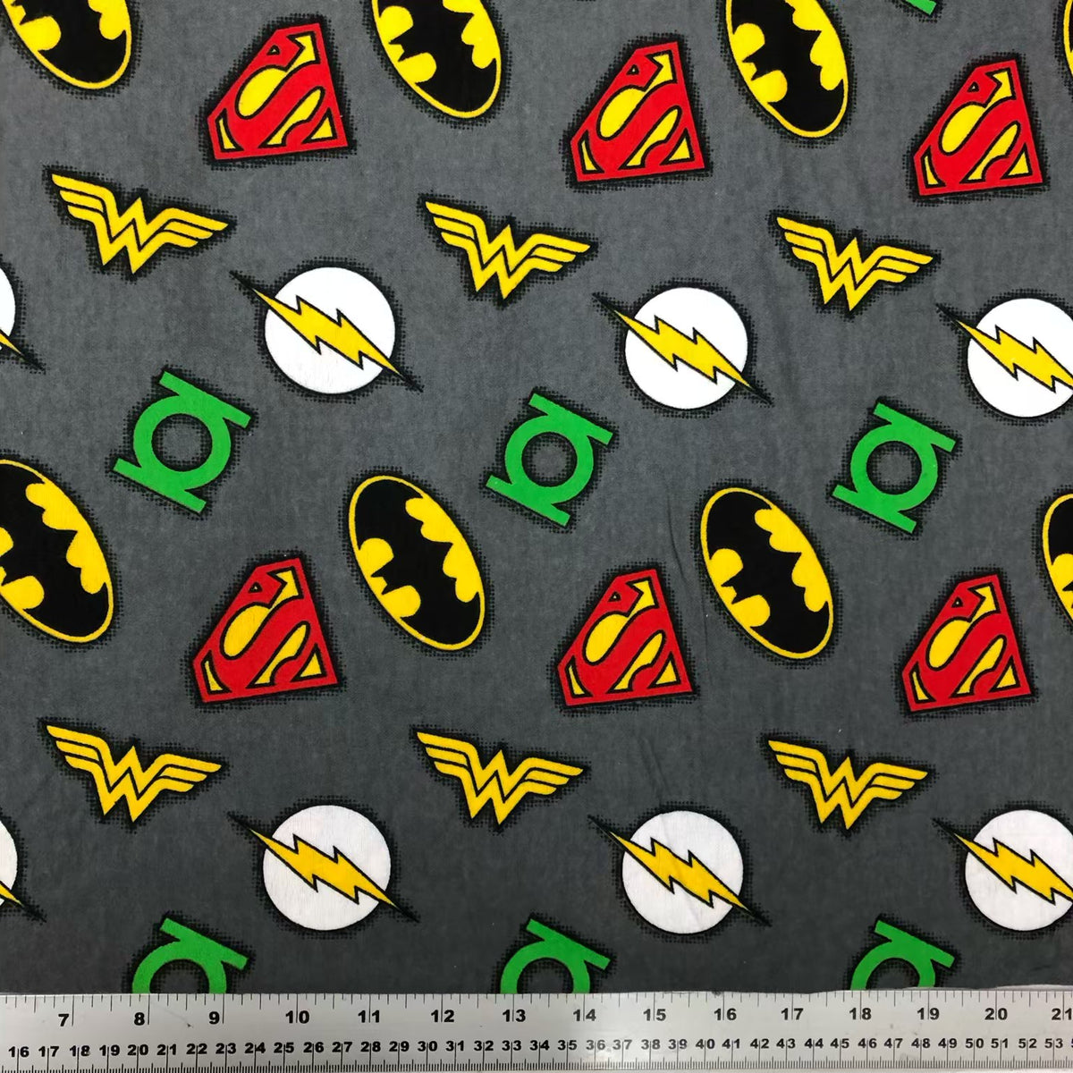 Grey cotton flannel with repeating Superman, Batman, Wonder Woman, Flash and Green Lantern logos