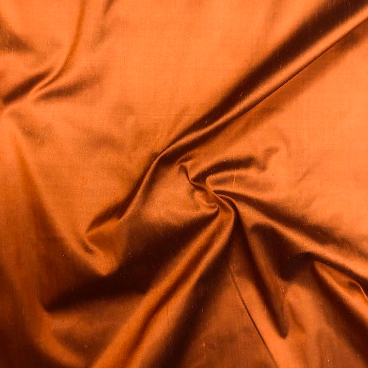 Dupioni silk fabric in aztec orange with crisp textured finish