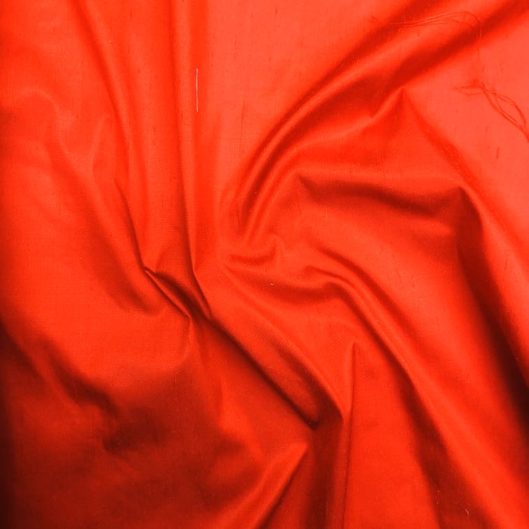 Dupioni silk fabric in red with crisp textured finish