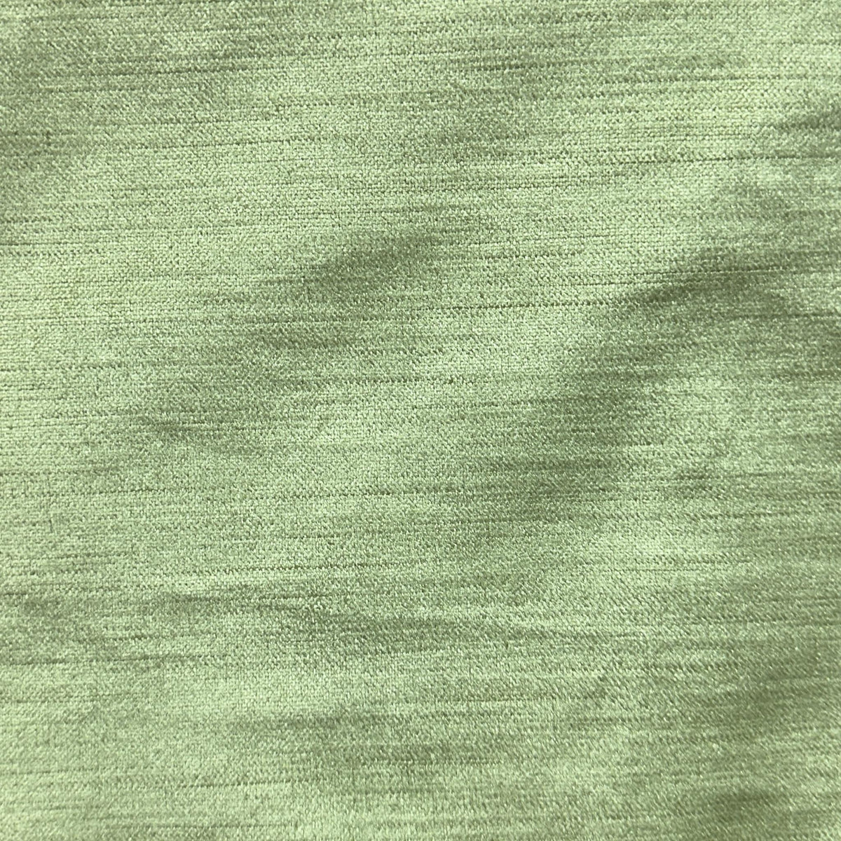Solid green velvet upholstery fabric with a soft, smooth pile and subtle tonal texture