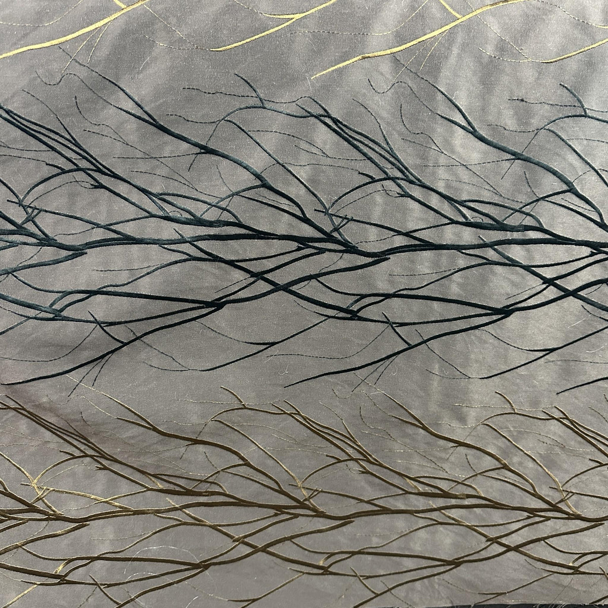 Grey, black and gold wide-width drapery fabric with a decorative branch pattern