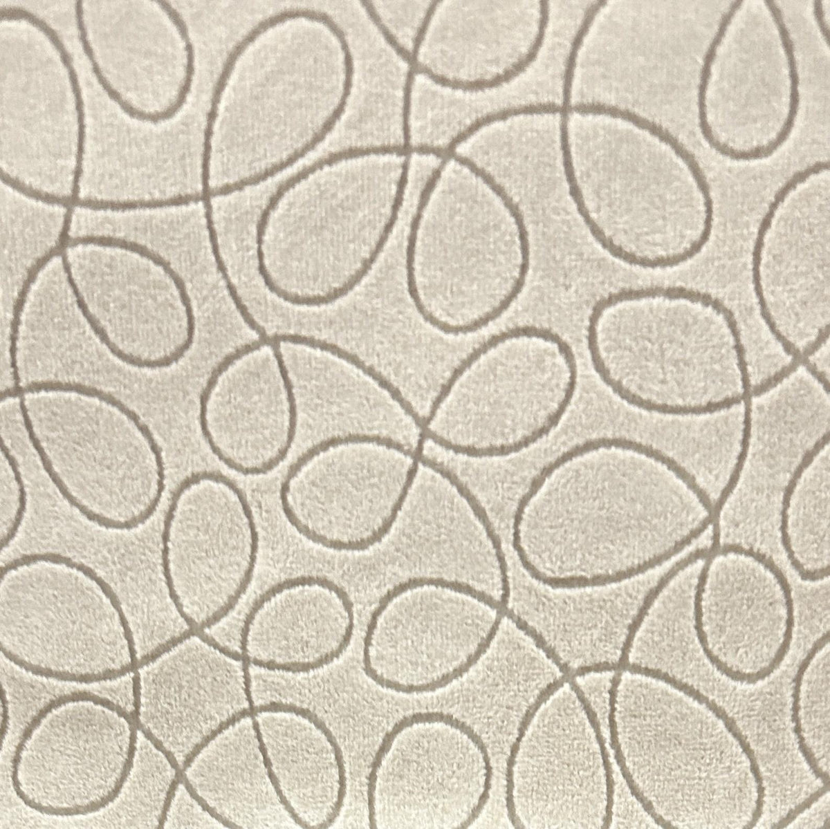 Cream velvet upholstery fabric with taupe looping scribble lines and a soft textured surface
