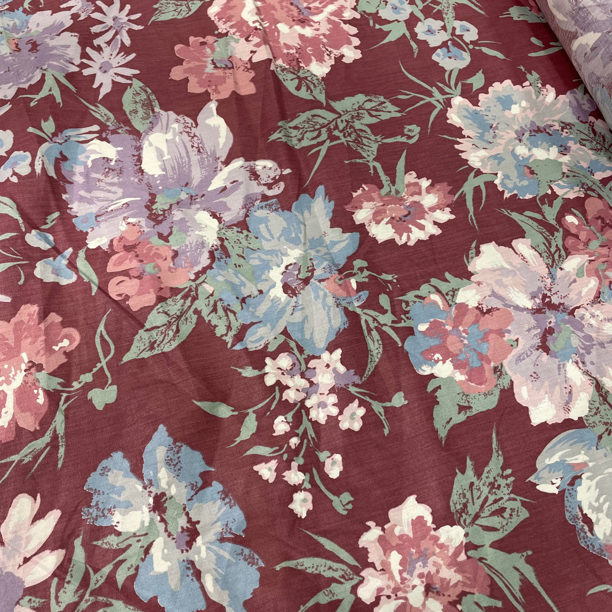 Maroon multicolour poly-cotton fabric with a decorative floral print