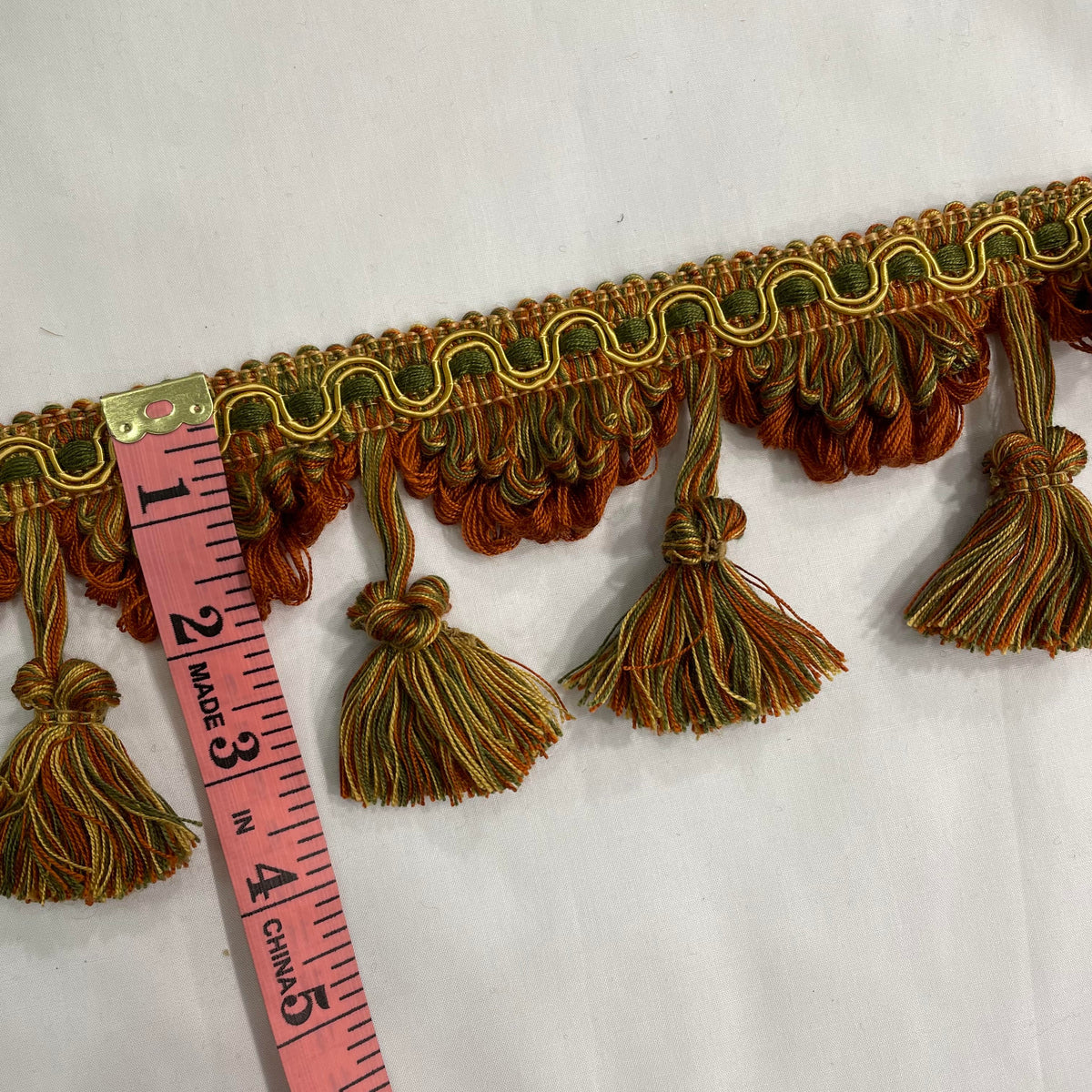 Orange, green and yellow 3.5-inch polyester tassel trim with decorative hanging tassels