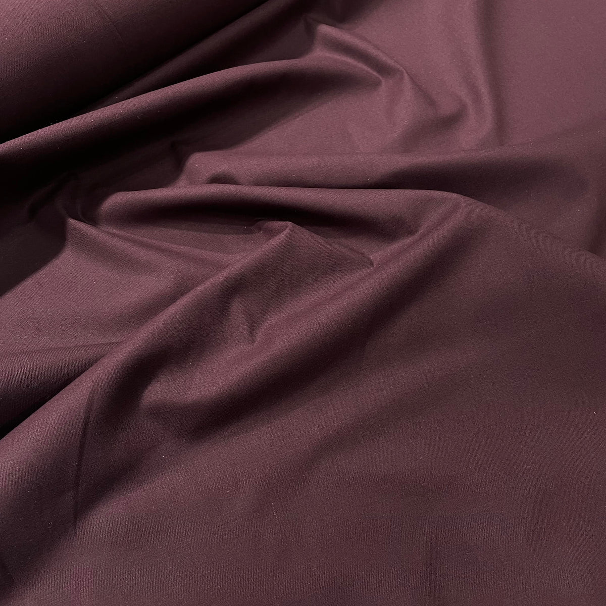 Plum purple cotton twill fabric with a durable diagonal woven texture