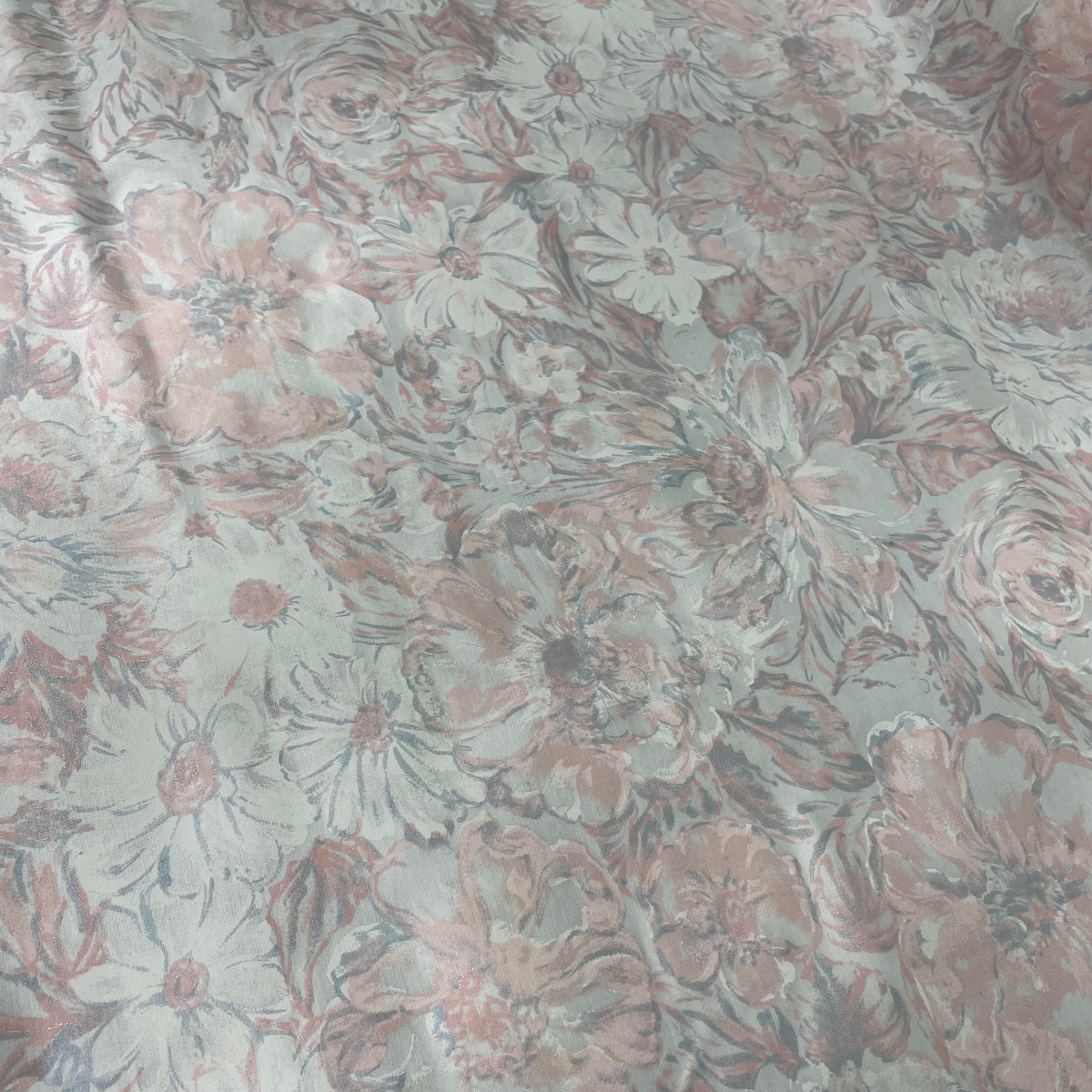 Blue and orange polyester fabric with a soft pastel floral print