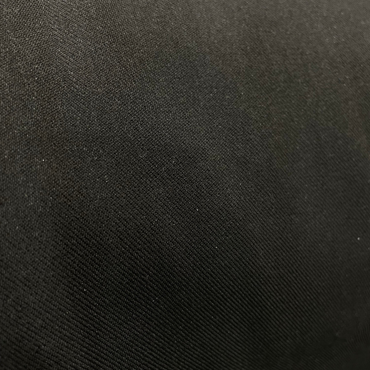 Black stretch suiting fabric with a fine woven surface and solid colour