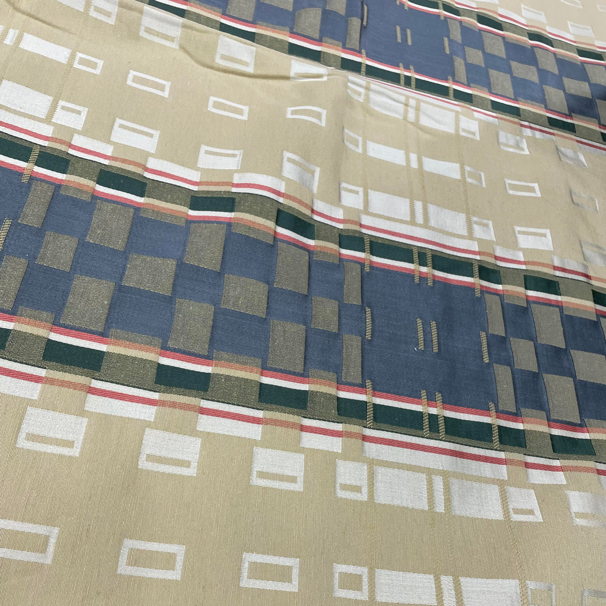 Green and yellow cotton upholstery fabric with geometric stripes and square-inspired shapes