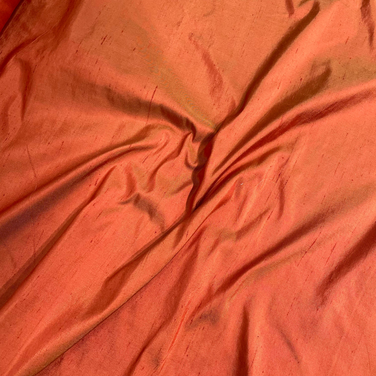 100% silk Dupioni terracotta orange fabric with textured surface