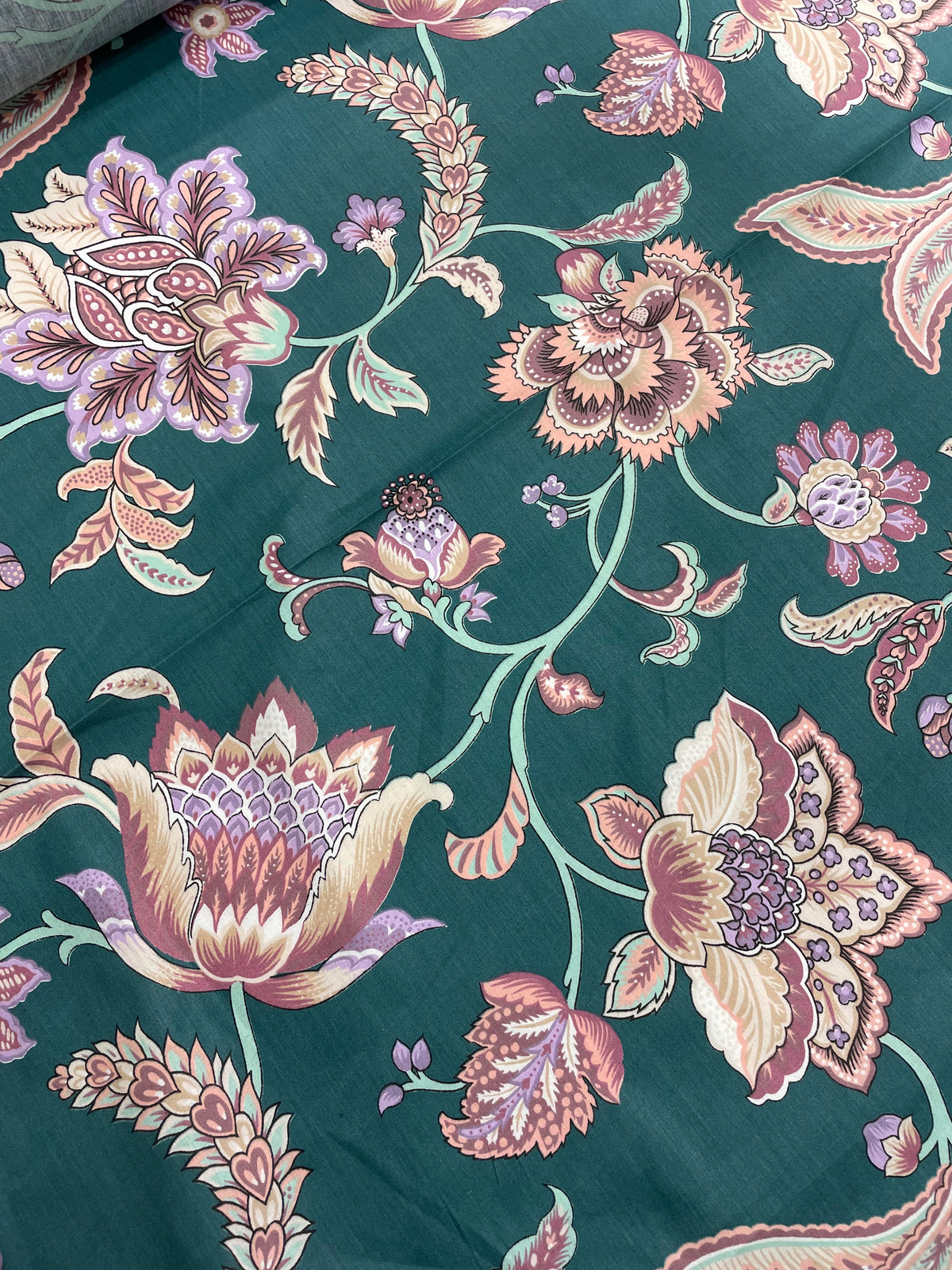 Green and pink cotton fabric with a colourful floral botanical print