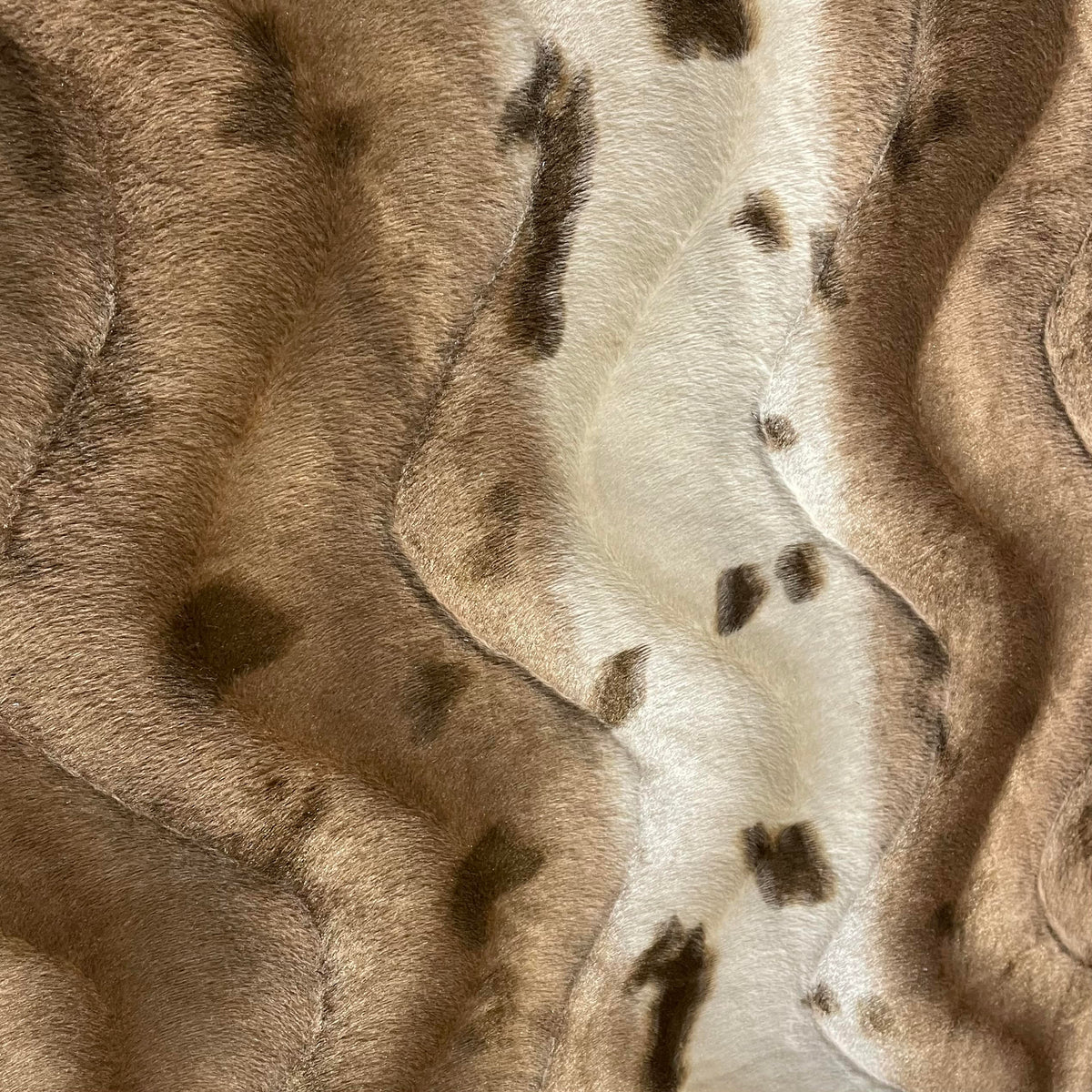 Brown velveteen fabric with a bold animal-inspired print and soft textured surface