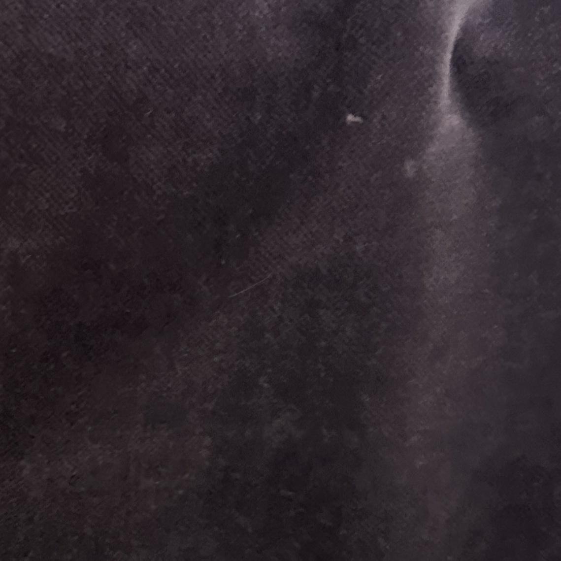Solid dark purple velvet upholstery fabric with a soft surface and subtle tonal texture