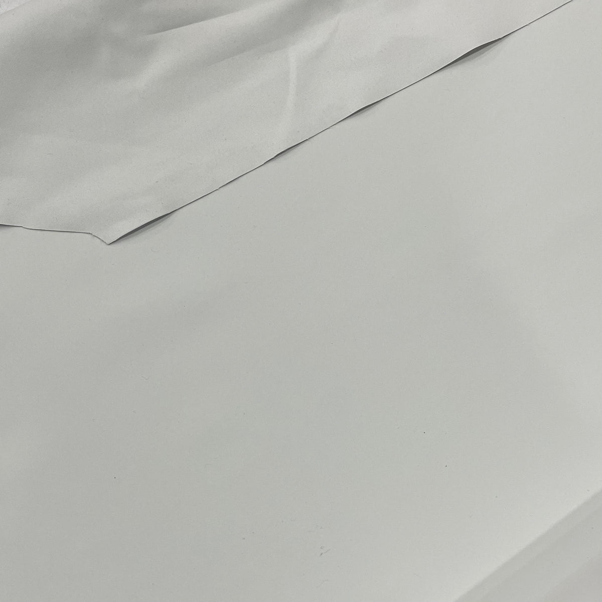 Two-sided white Eclipse blackout lining fabric with a smooth opaque surface
