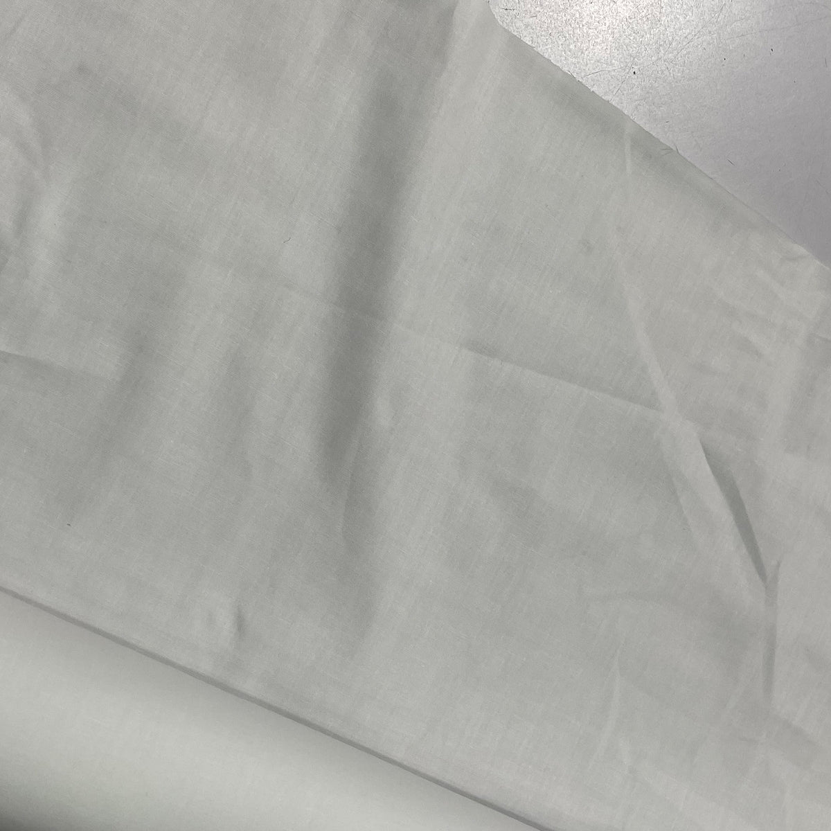 White extra wide drapery lining fabric with a smooth, tightly woven surface