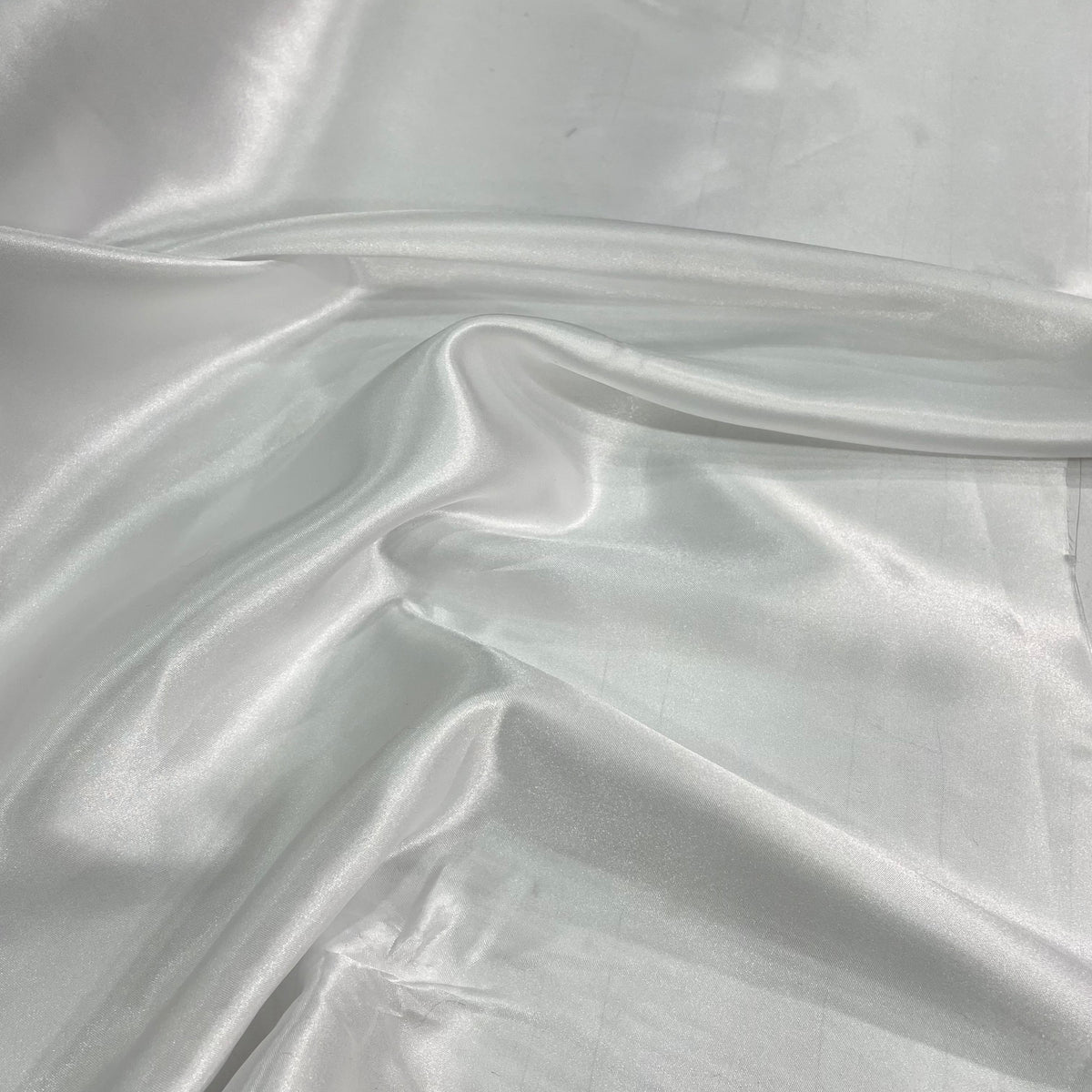 White polyester satin fabric with a smooth lustrous surface and clean solid colour