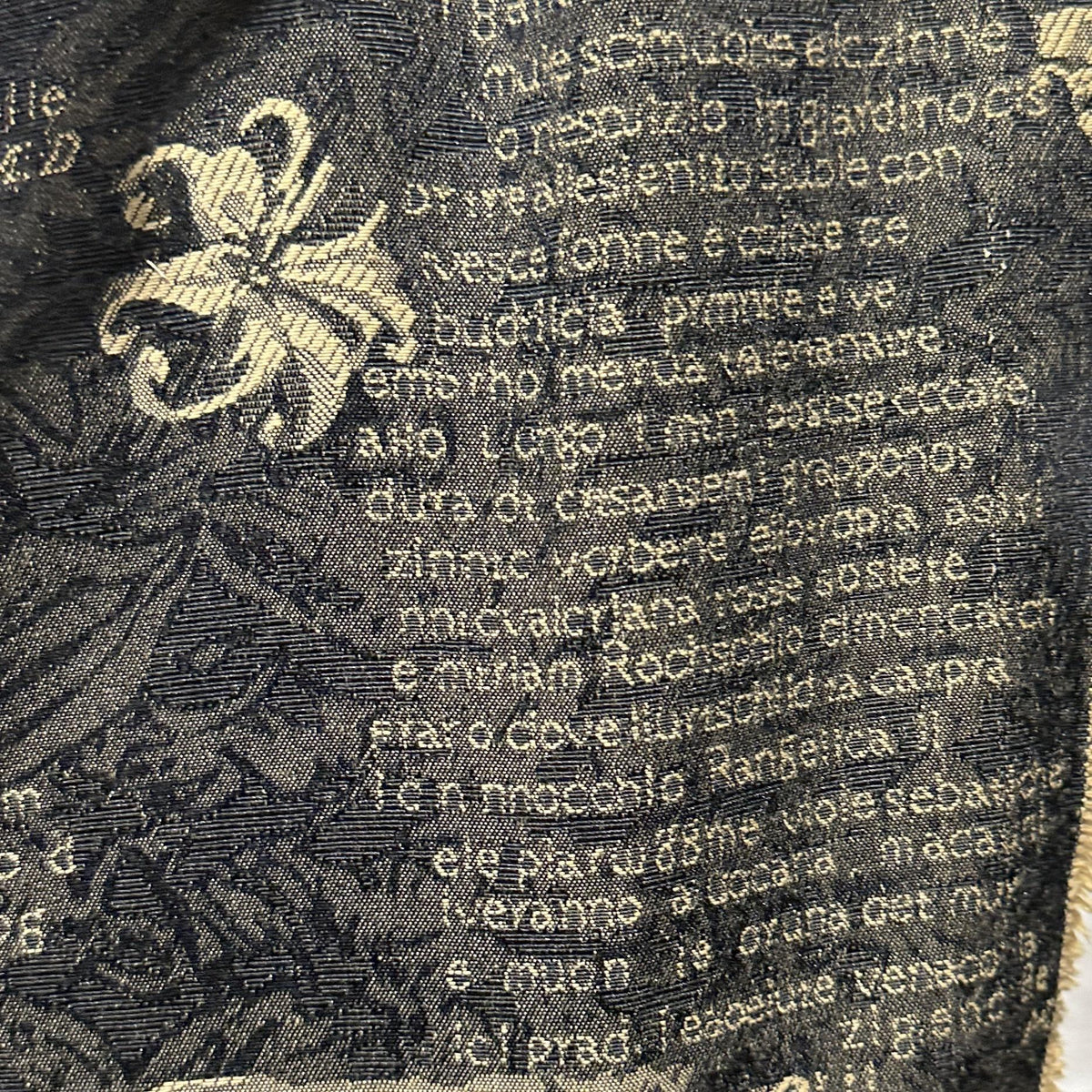 Black polyester upholstery fabric with vintage script, scrollwork and ornamental motifs