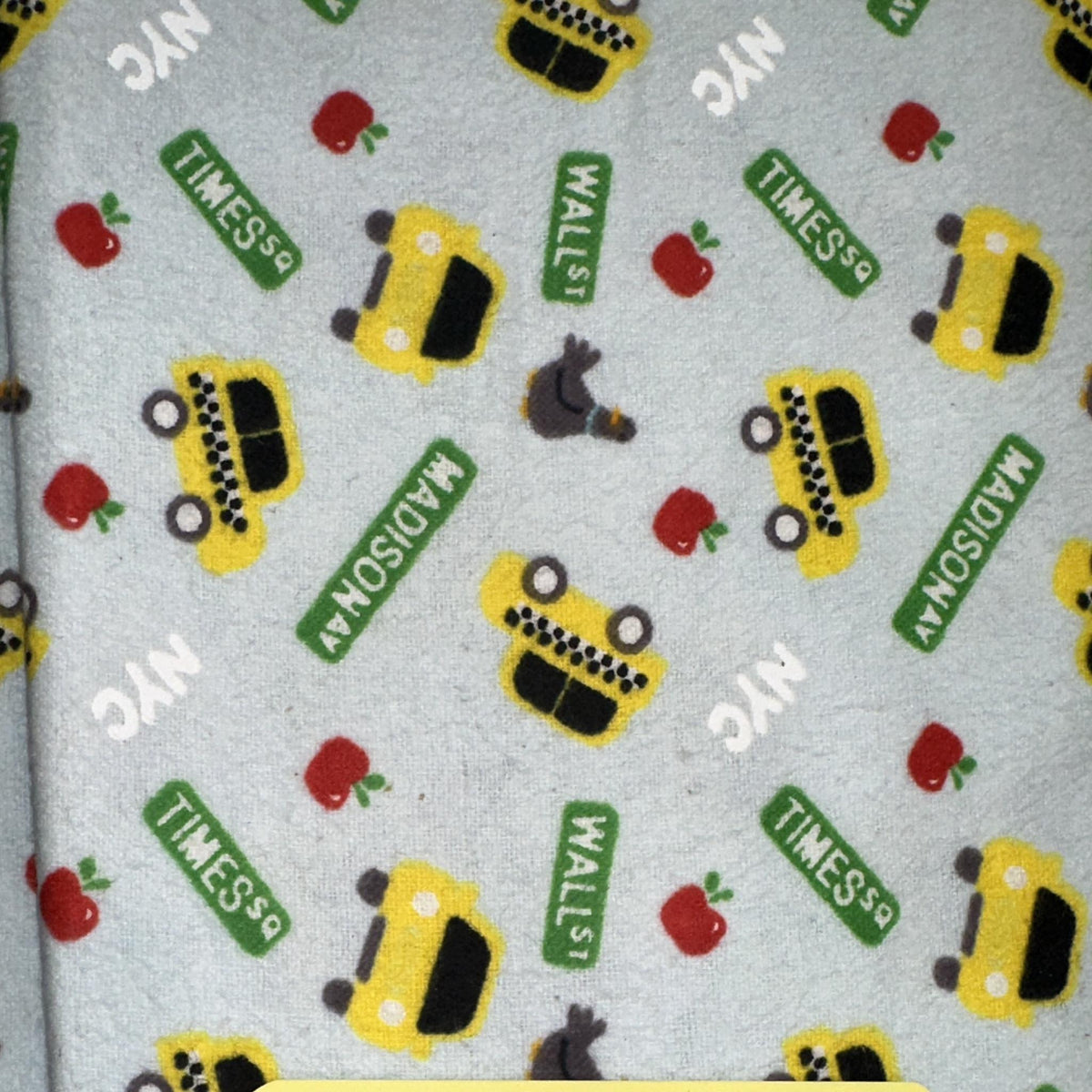 Grey flannel fabric with New York yellow taxi cabs and city-inspired motifs