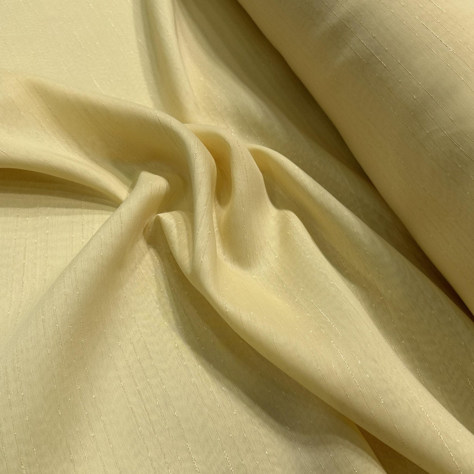 Gold wide-width sheer polyester drapery fabric with a textured finish