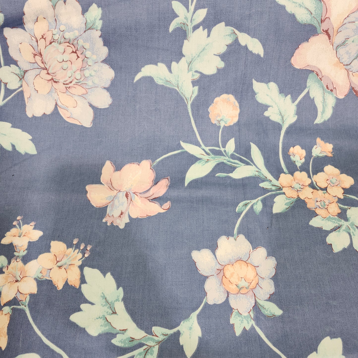 Beige floral 100% cotton fabric with a printed flower pattern and smooth woven texture