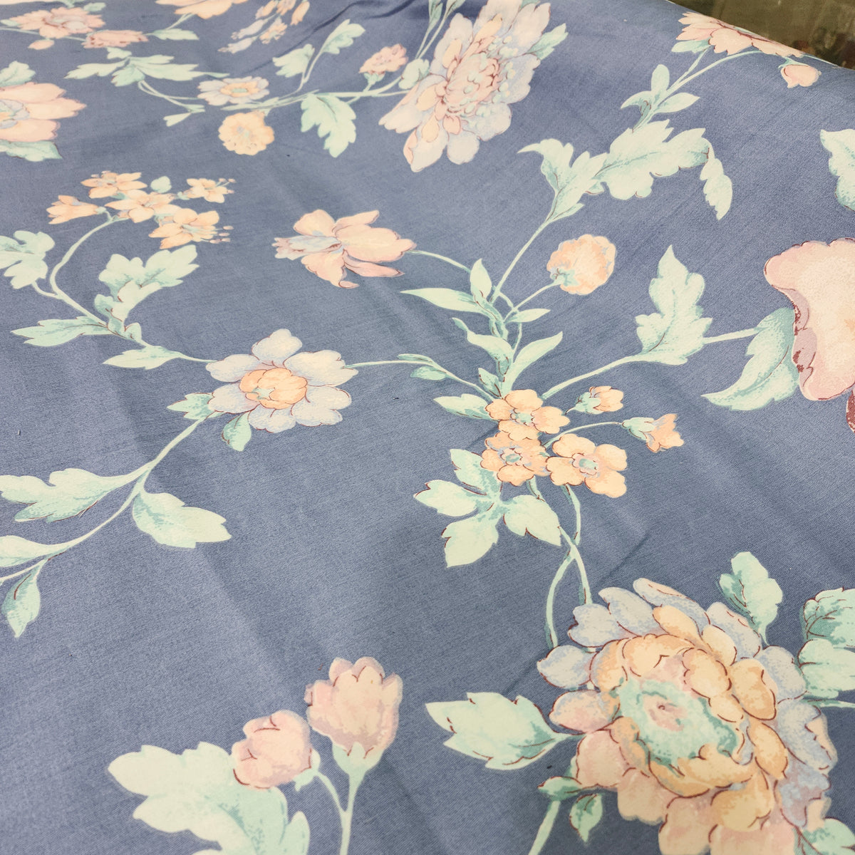 Beige floral 100% cotton fabric with a printed flower pattern and smooth woven texture