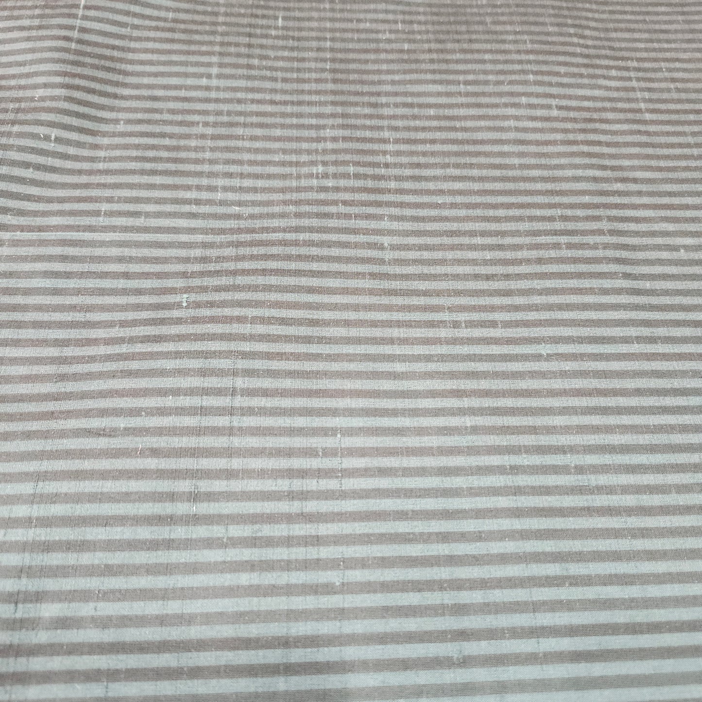 Green and black striped silk fabric with a smooth finish and elegant woven texture
