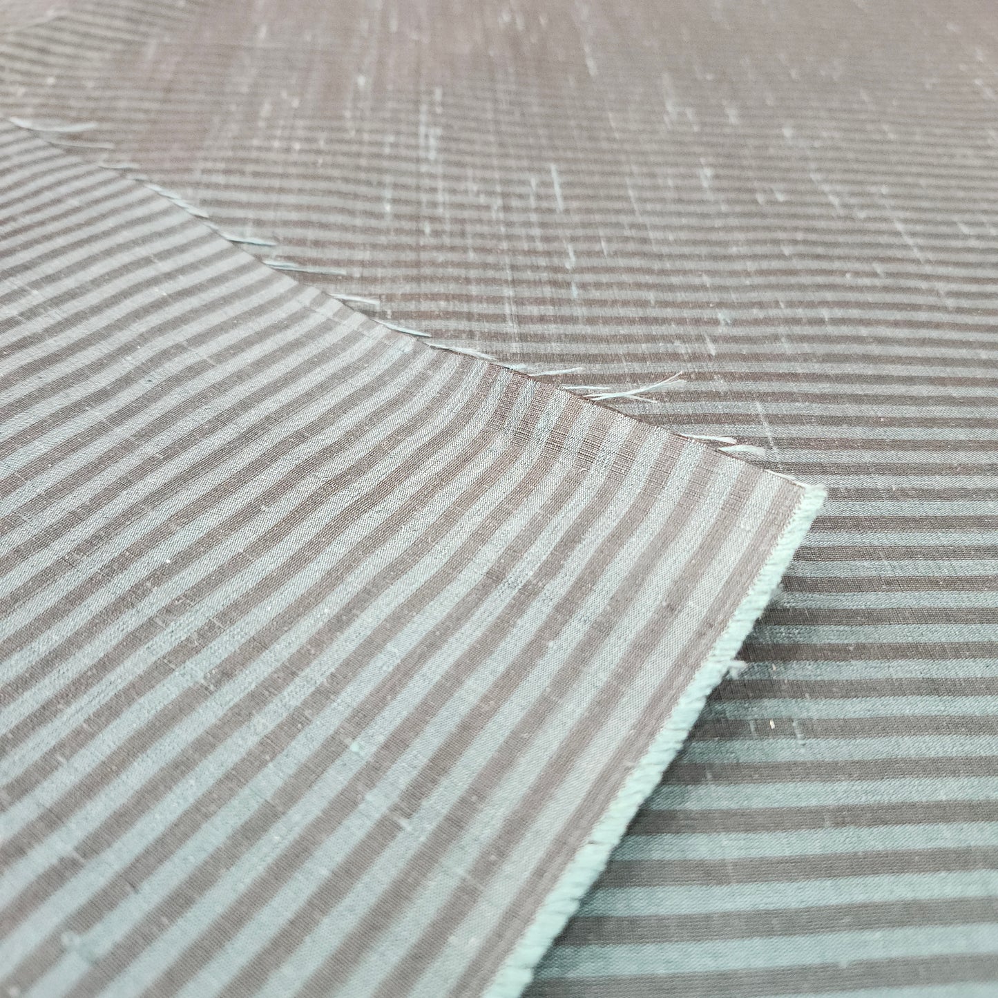 Green and black striped silk fabric with a smooth finish and elegant woven texture